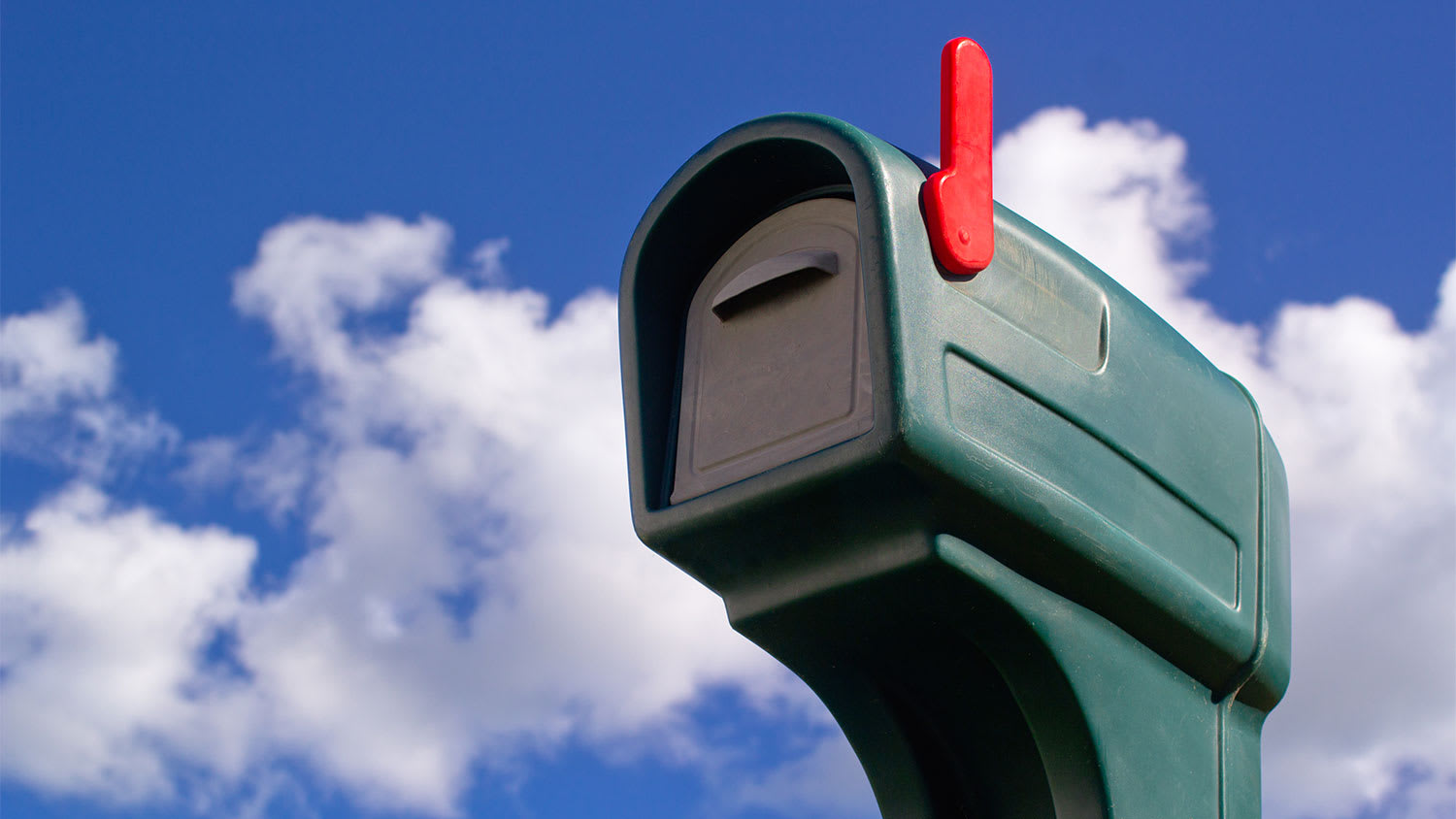A view of a green plastic mailbox