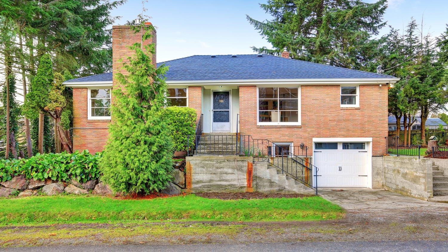 A two story red brick house with a garage