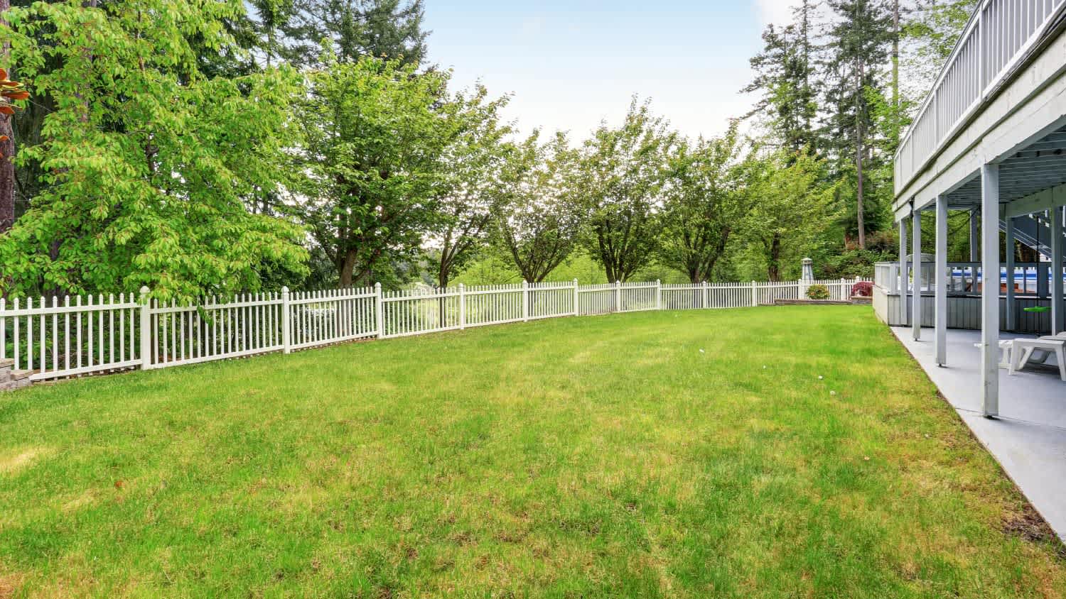 White lattice gazebo in backyard