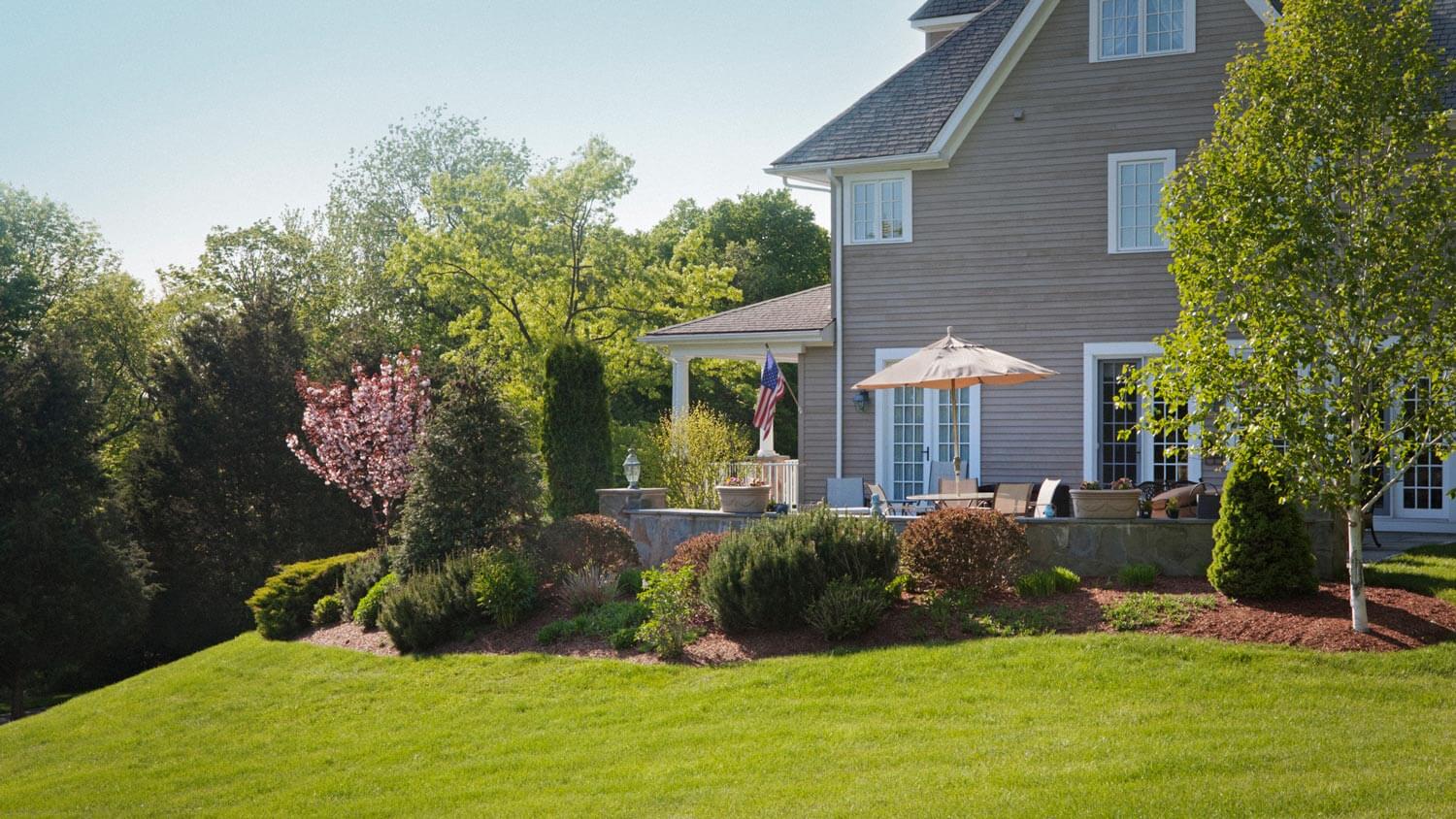 A fiber cement siding on a house with a big garden