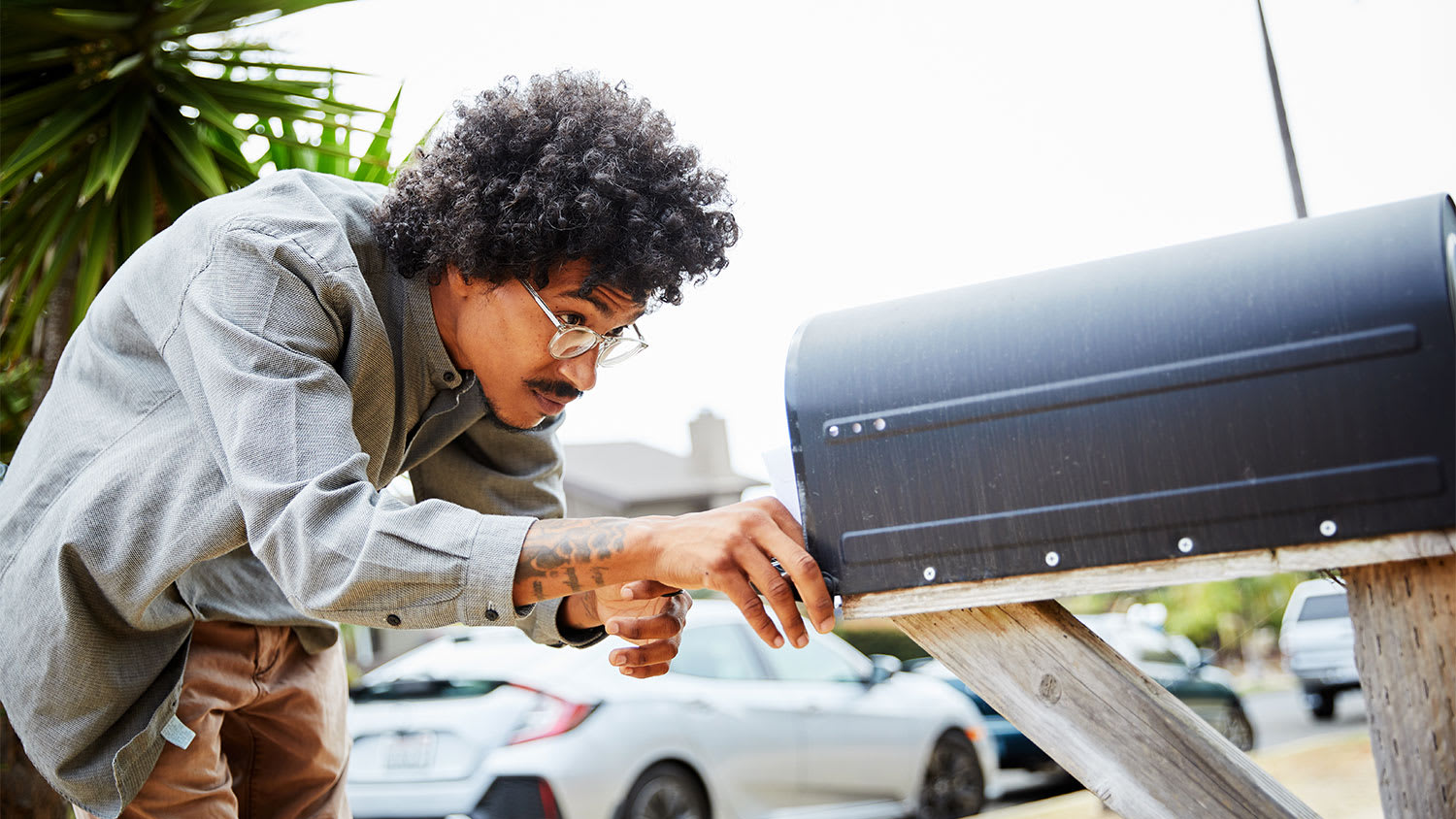 A man checks a mailbox