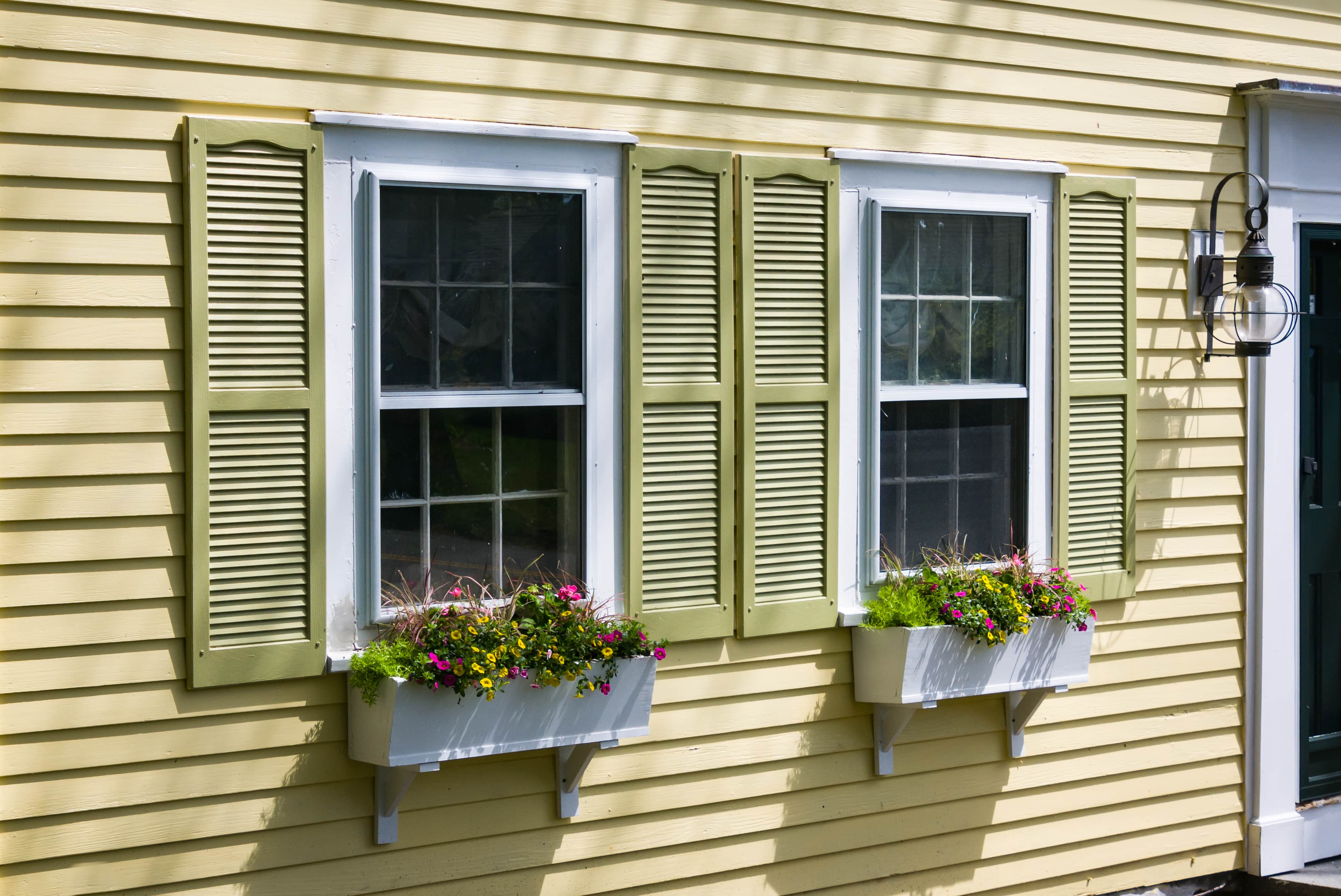 Flower boxes hung underneath exterior windows