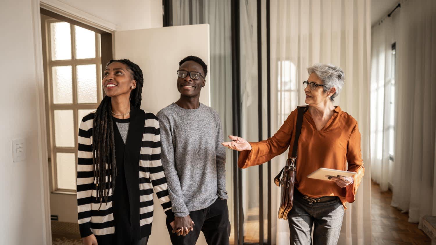Real estate agent showing apartment to young couple