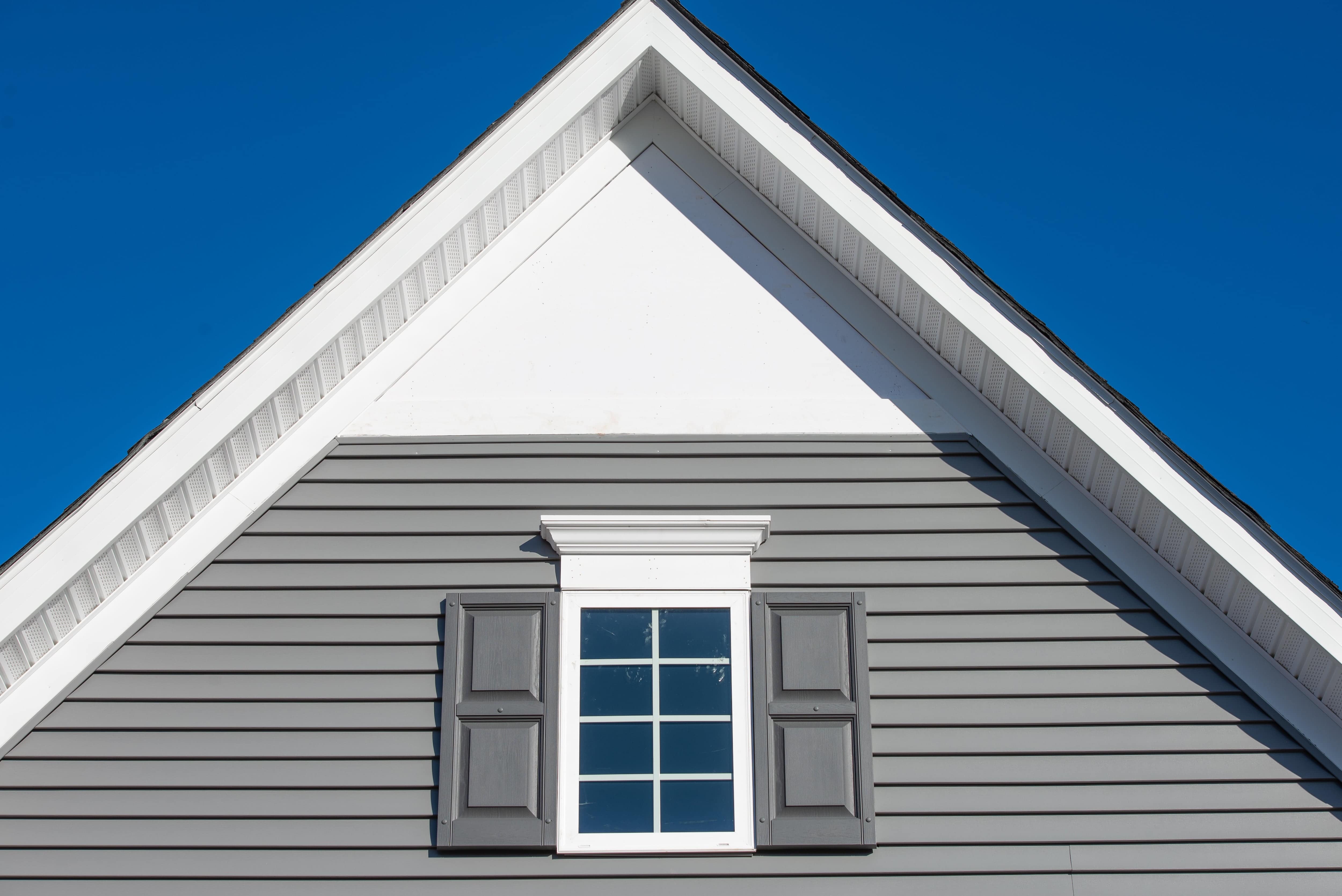 Gable roof with white window and window header trim