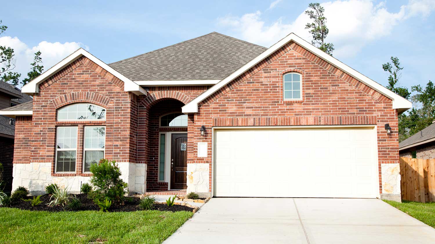 House with new brick siding and white garage door