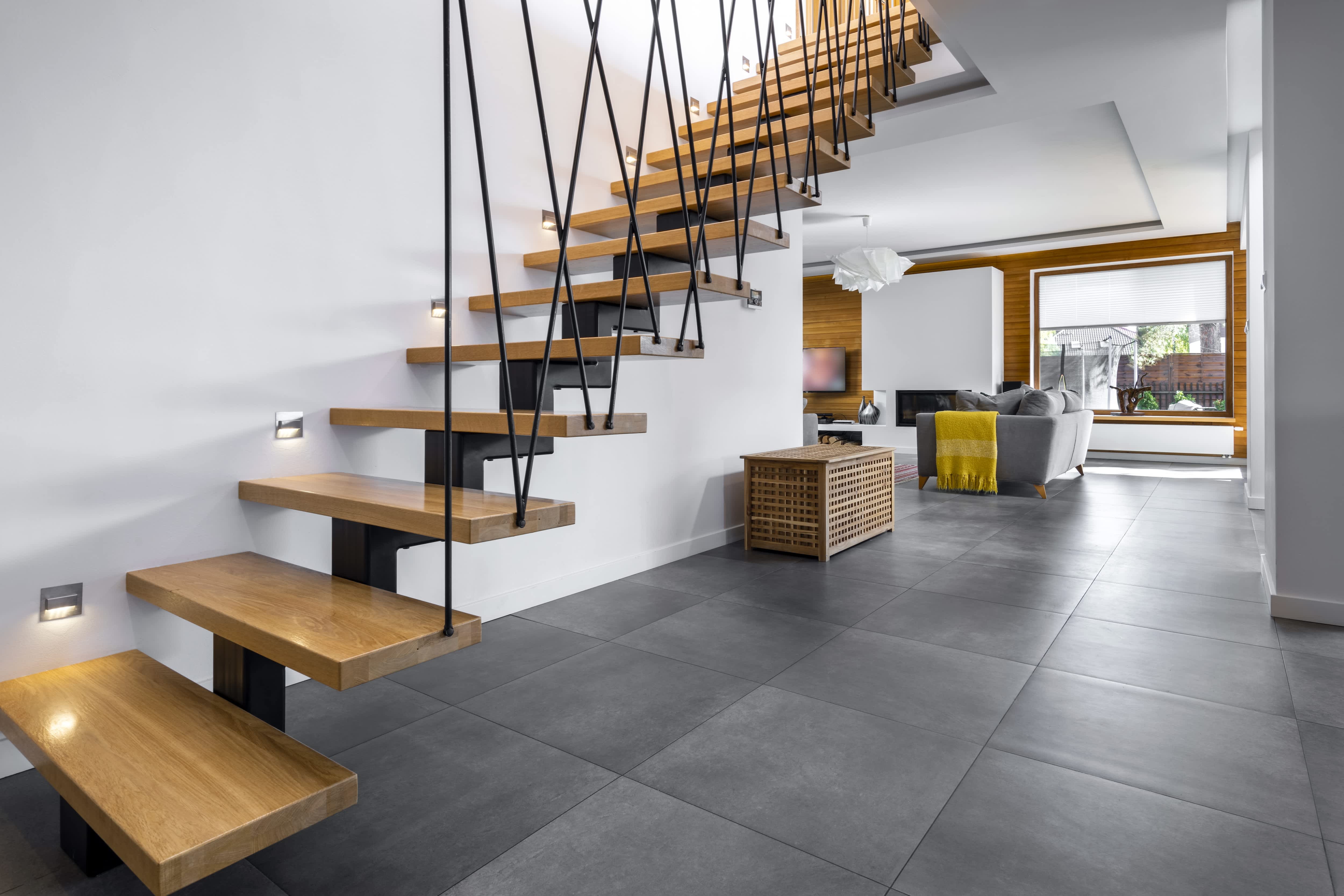 Modern floating staircase with metal floor-to-ceiling rail system