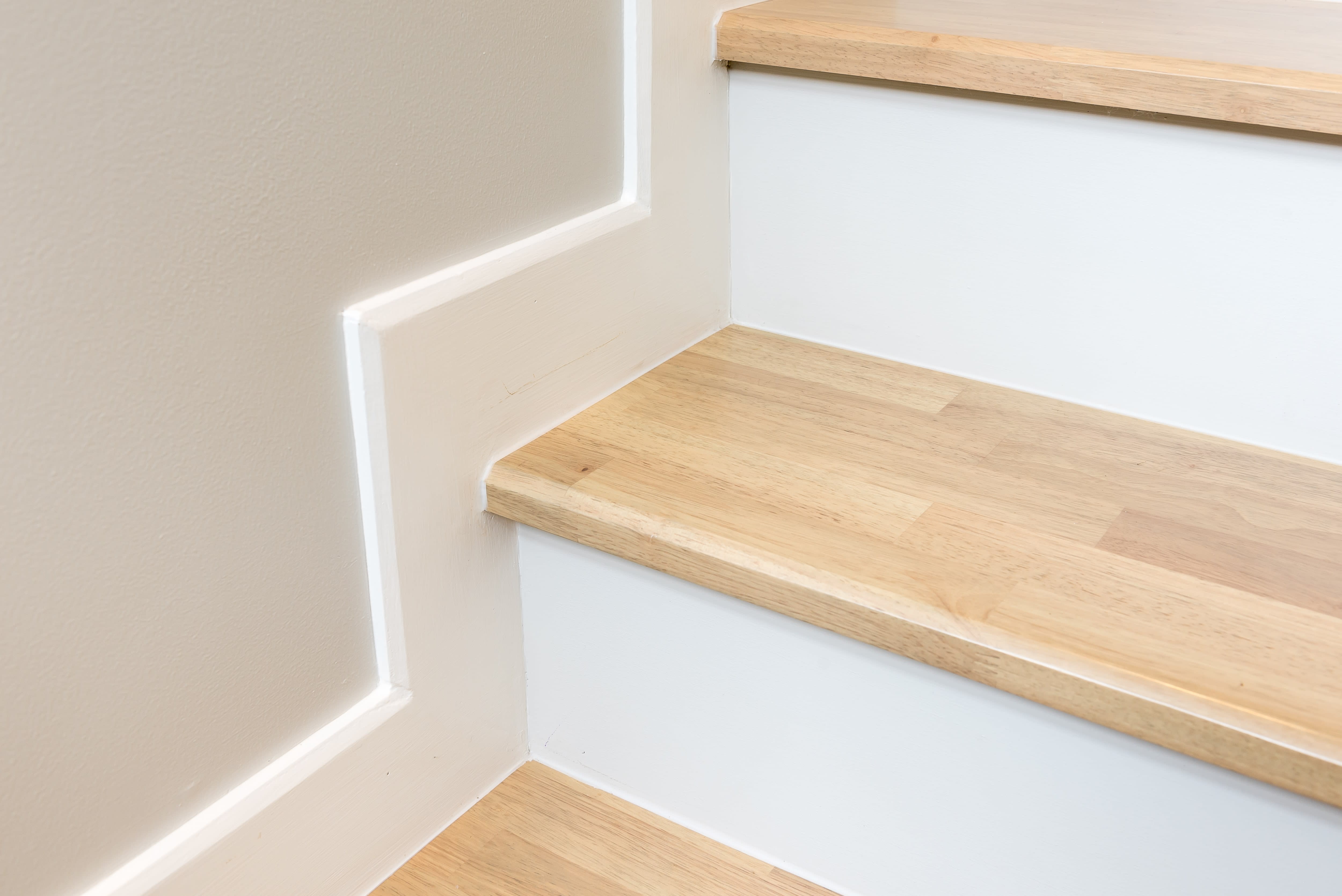 Skirt board trim above wooden staircase