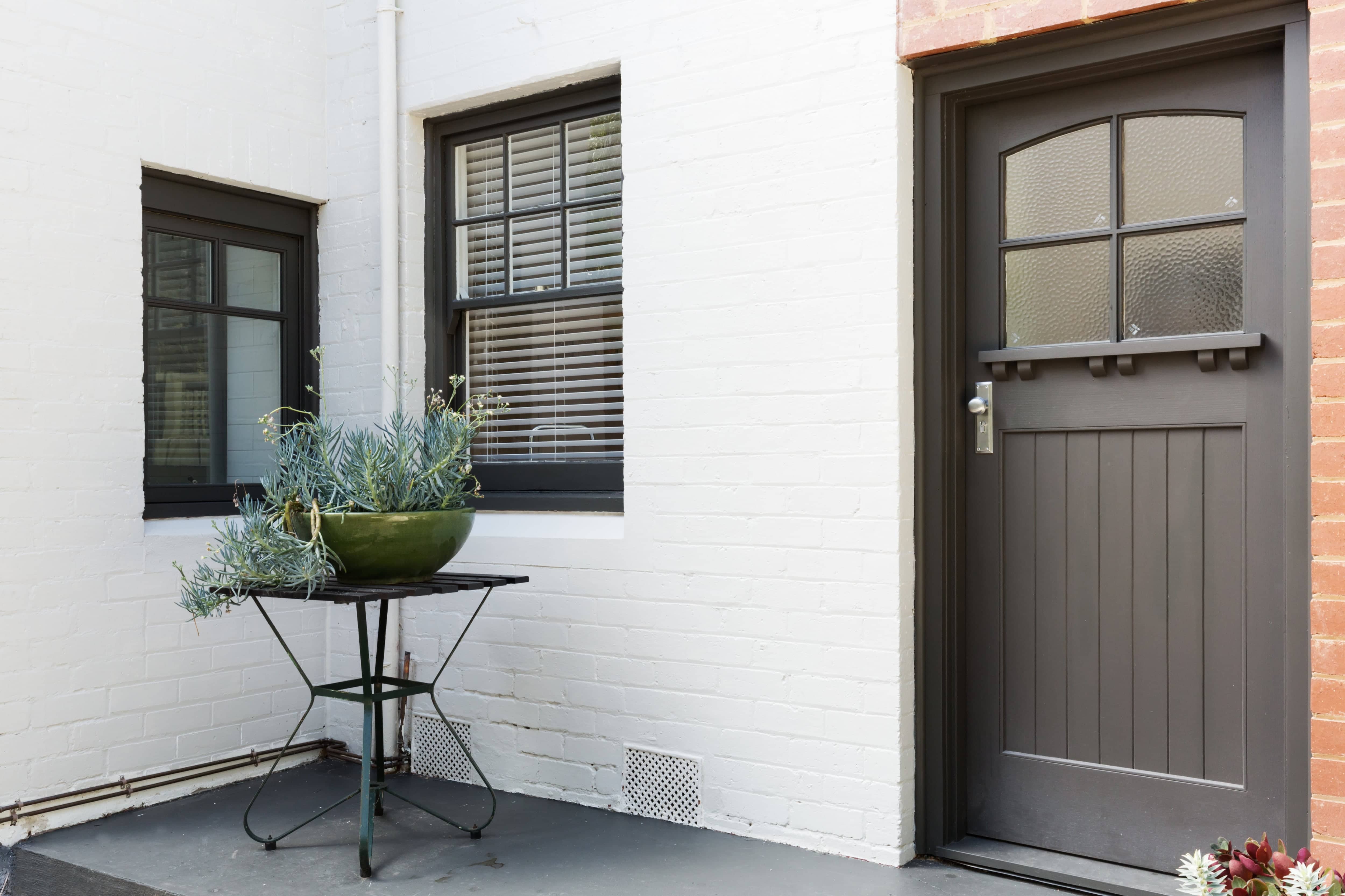 Modern home entryway with black windows and door