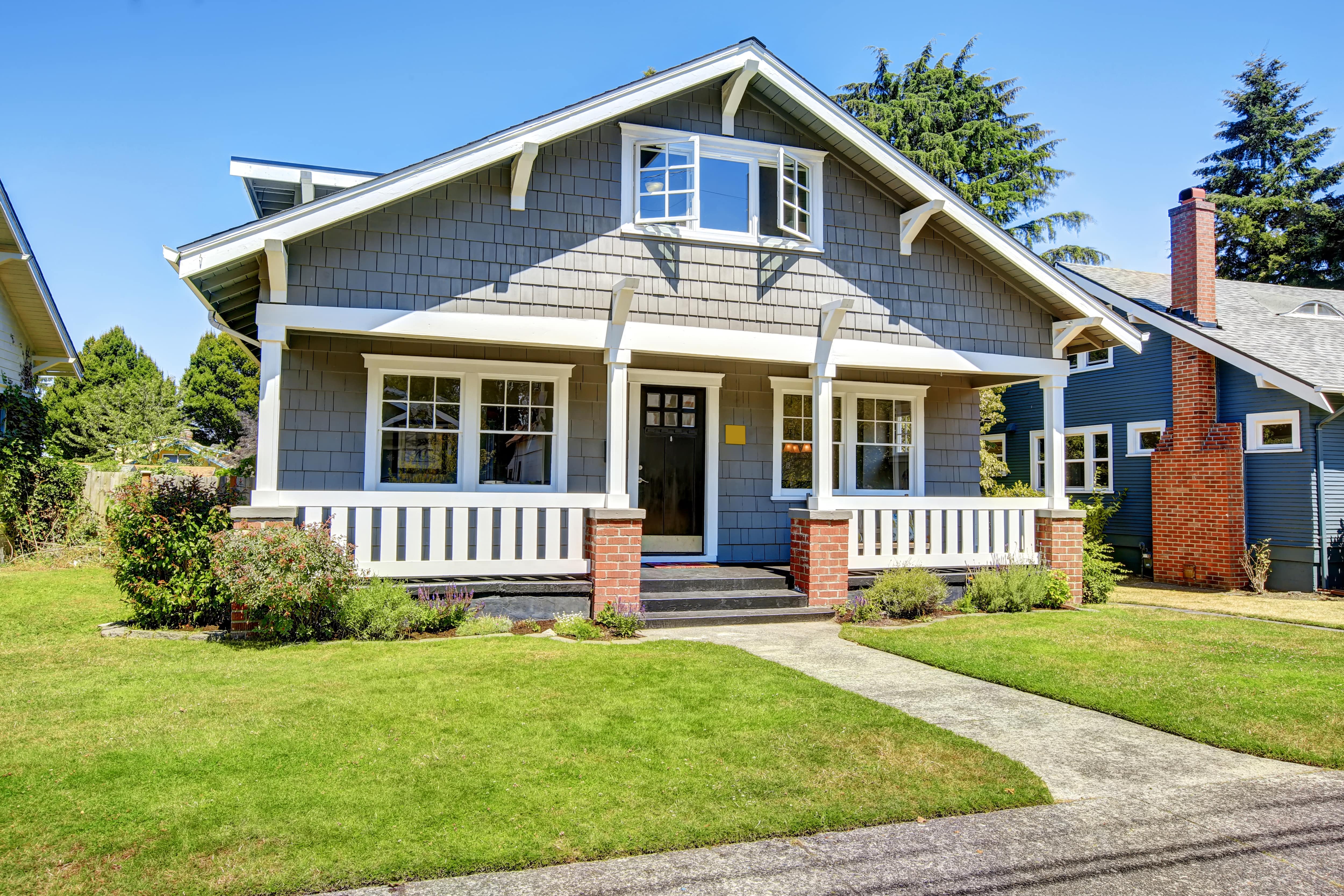 Gray home exterior with white window trim