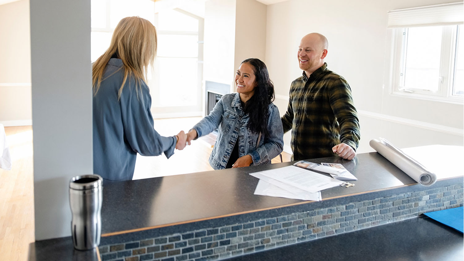 realtor shaking hands with couple
