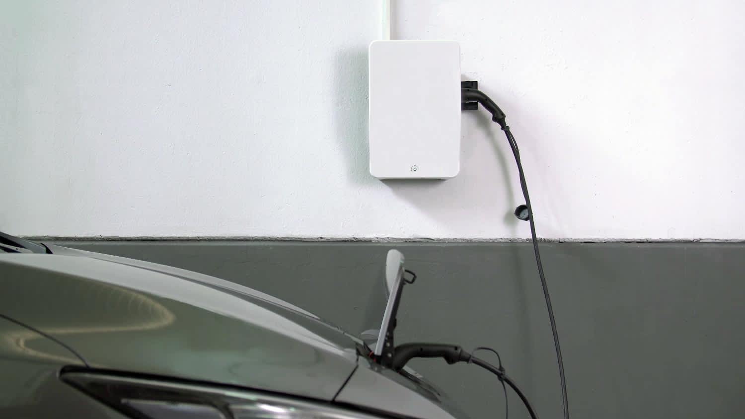 An electric car getting charged in a home installed charging station
