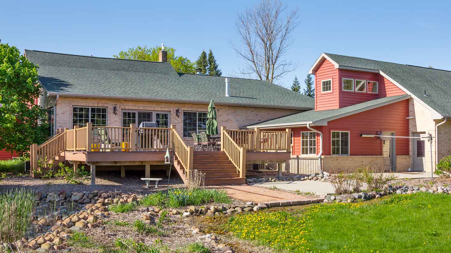 Large home with an attached wooden deck