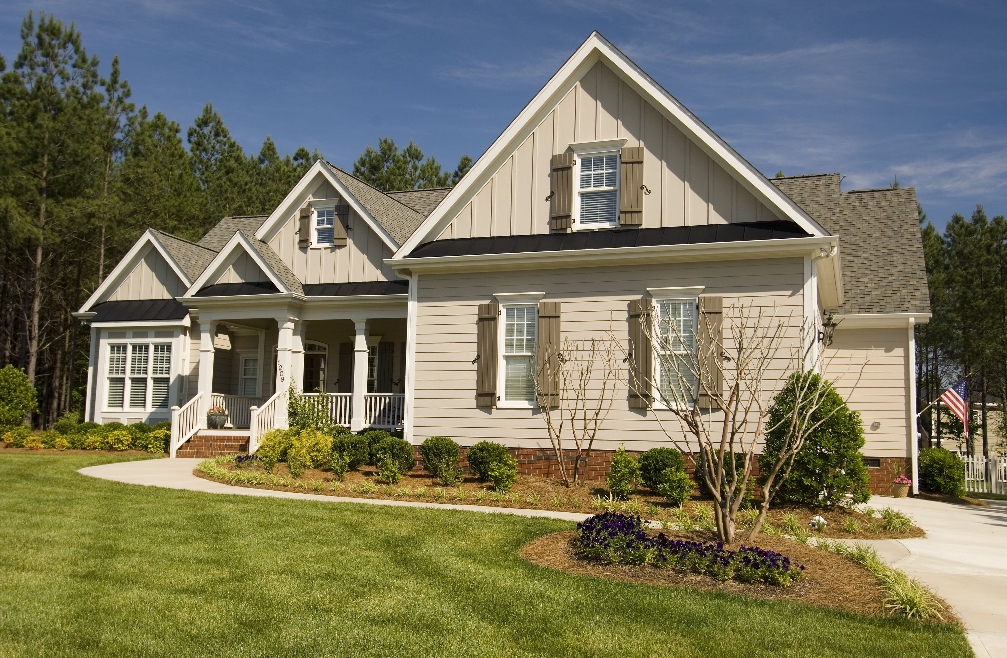 Large modern farmhouse home with window shutters
