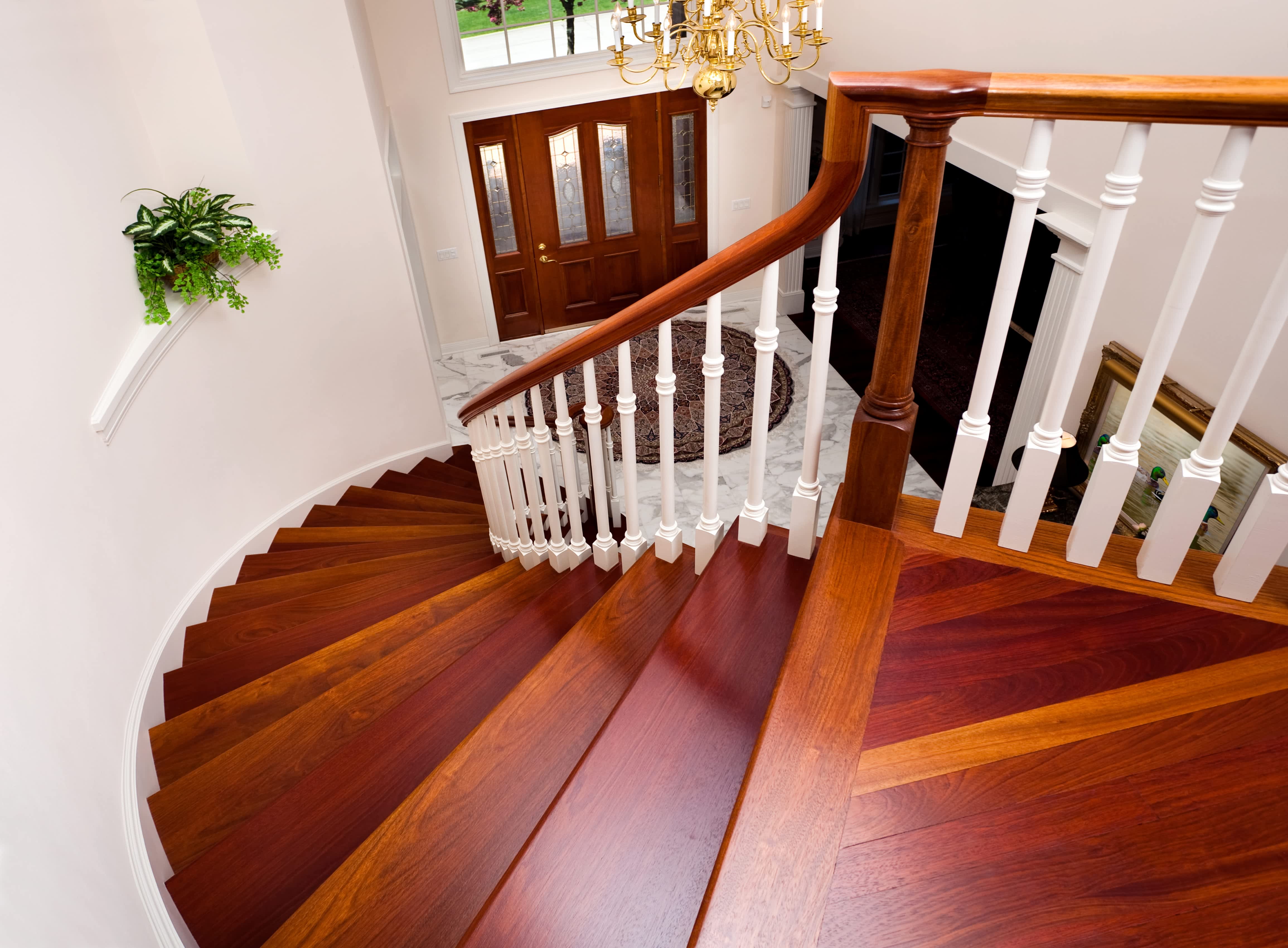 Grand wooden staircase in larger foyer