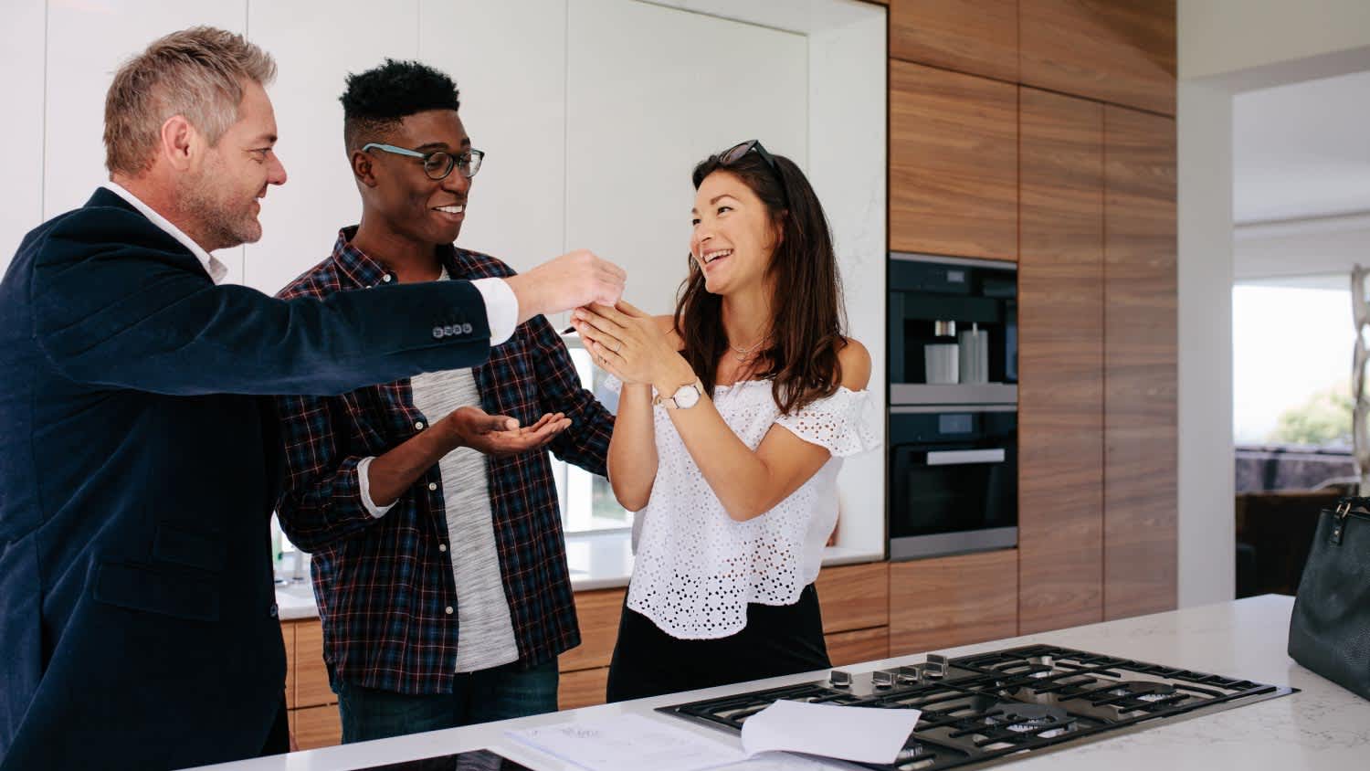 Realtor giving keys to new property owners