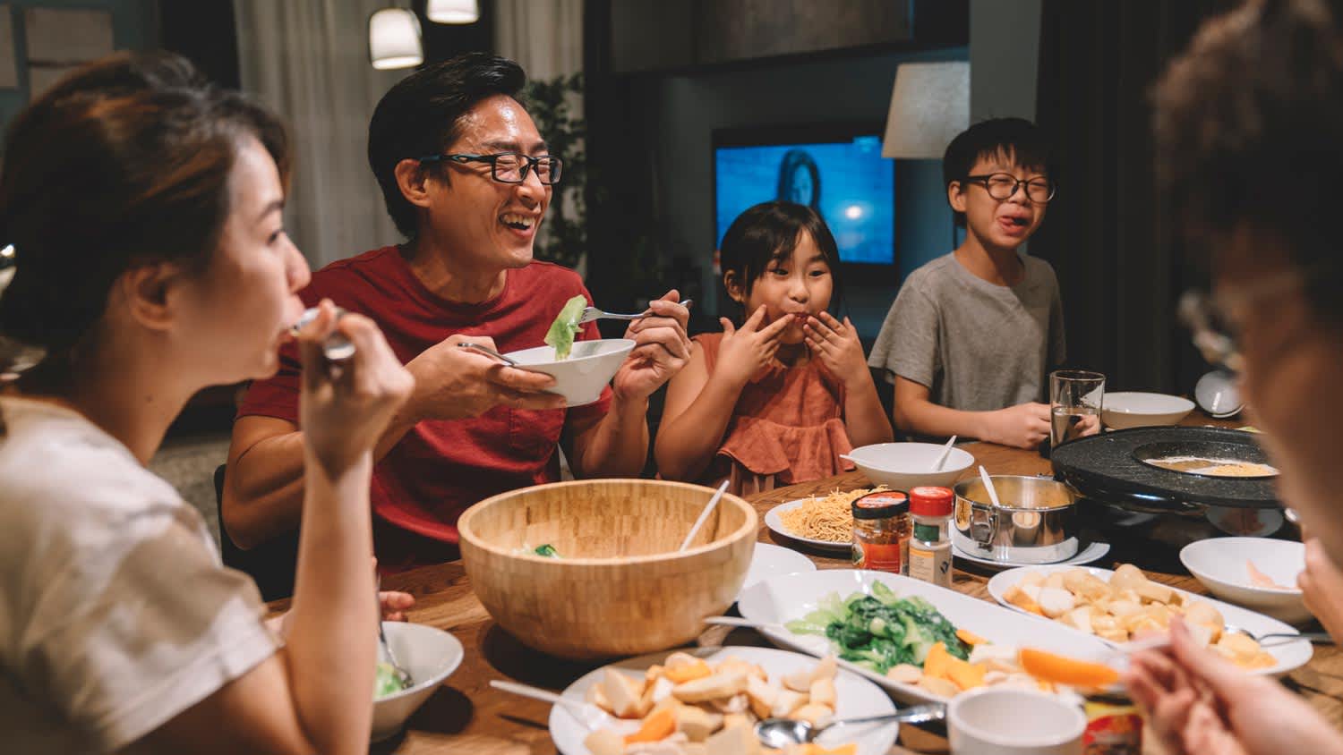 A family enjoying the dinner in their house