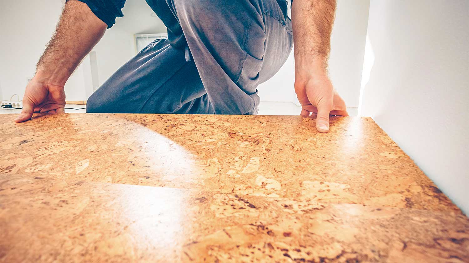 Man installing cork flooring