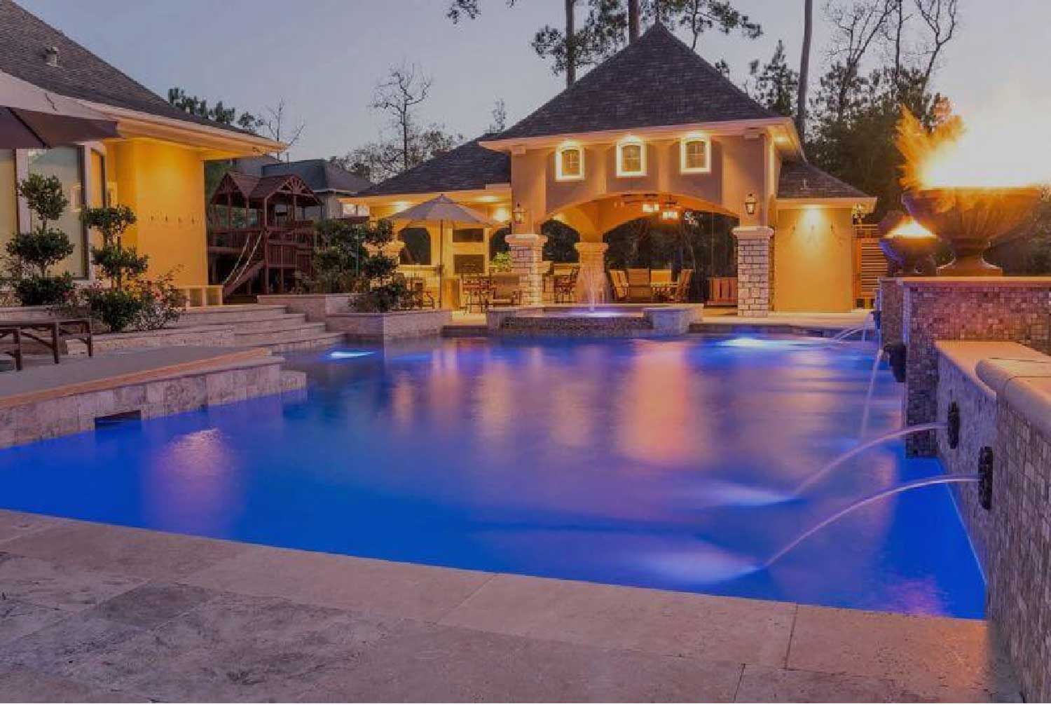 Raised wall geometric swimming pool with lighting