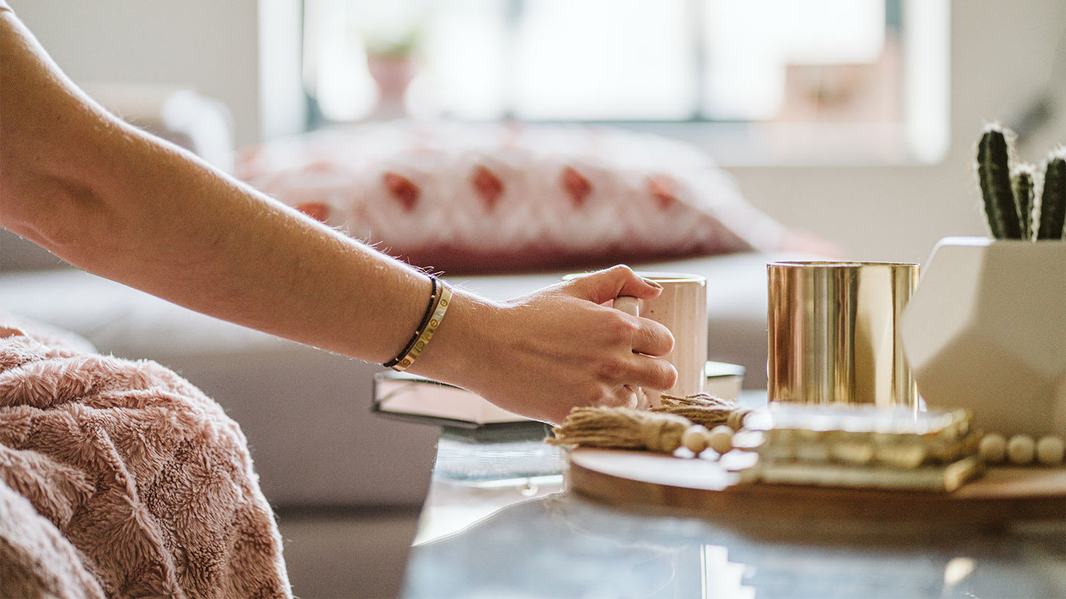 A woman places a mug on a marble table