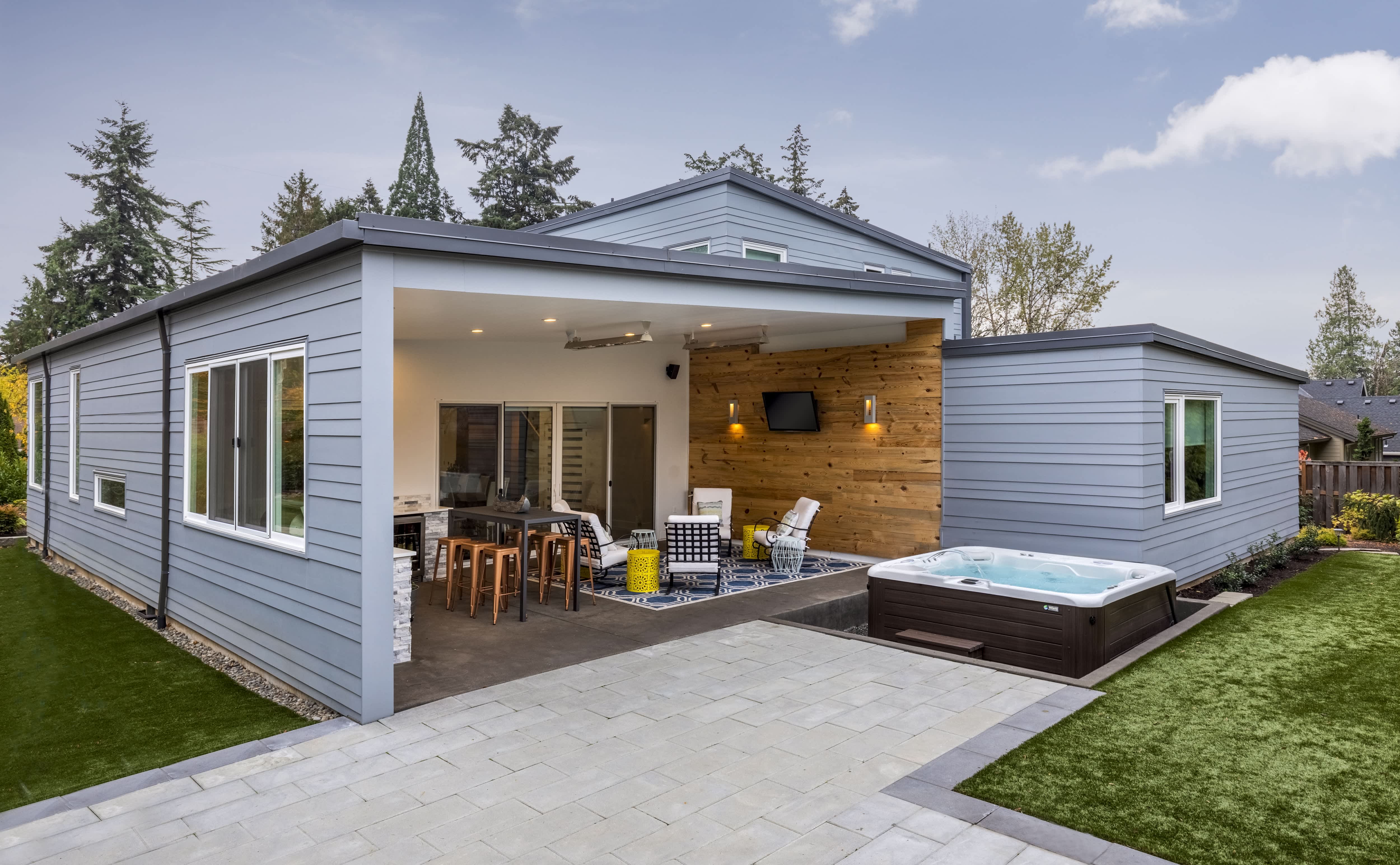Covered porch with seating area and hot tub
