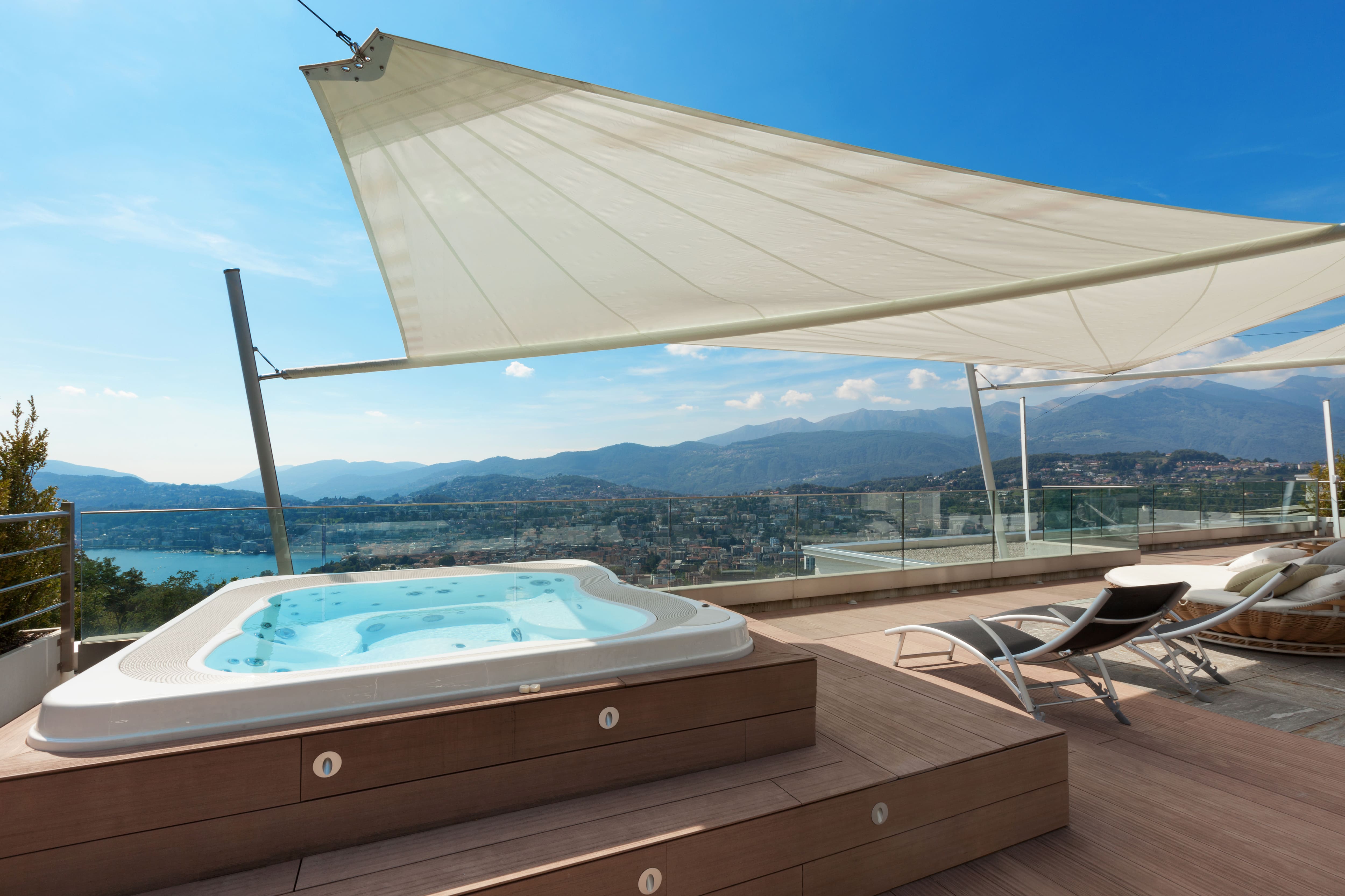 A rooftop deck with a raised hot tub
