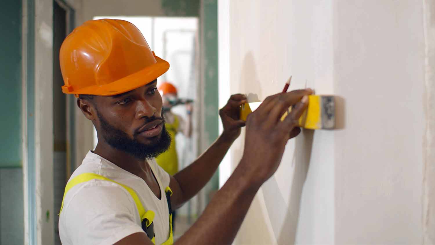 man using level on wall