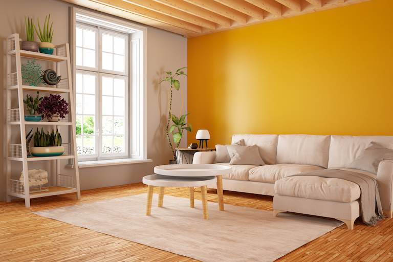 interior living room with glossy orange painted wall and tan furniture