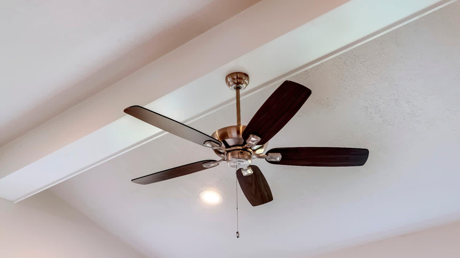 Decorative wood beam with standard ceiling fan
