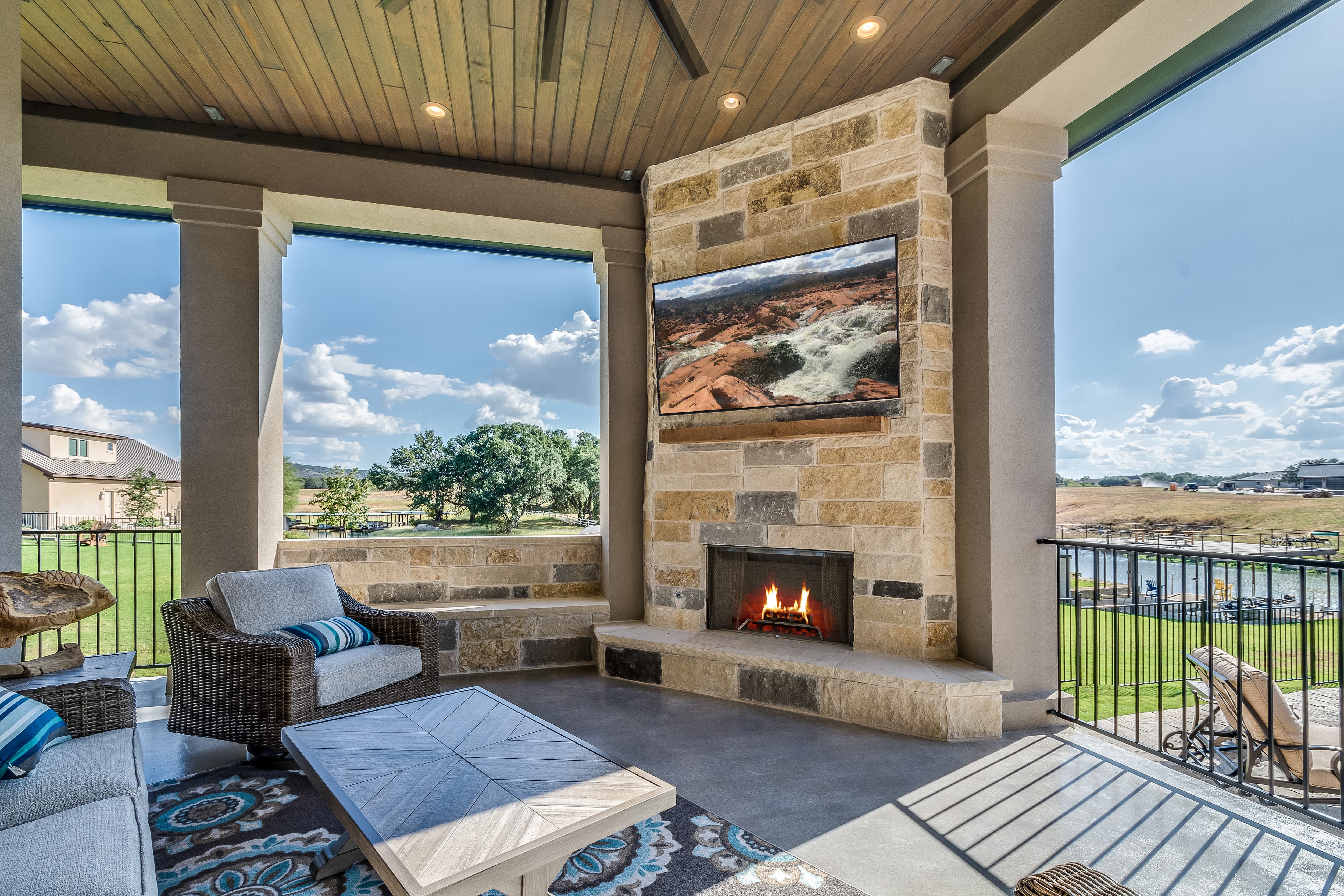 Outdoor TV and fireplace under covered porch