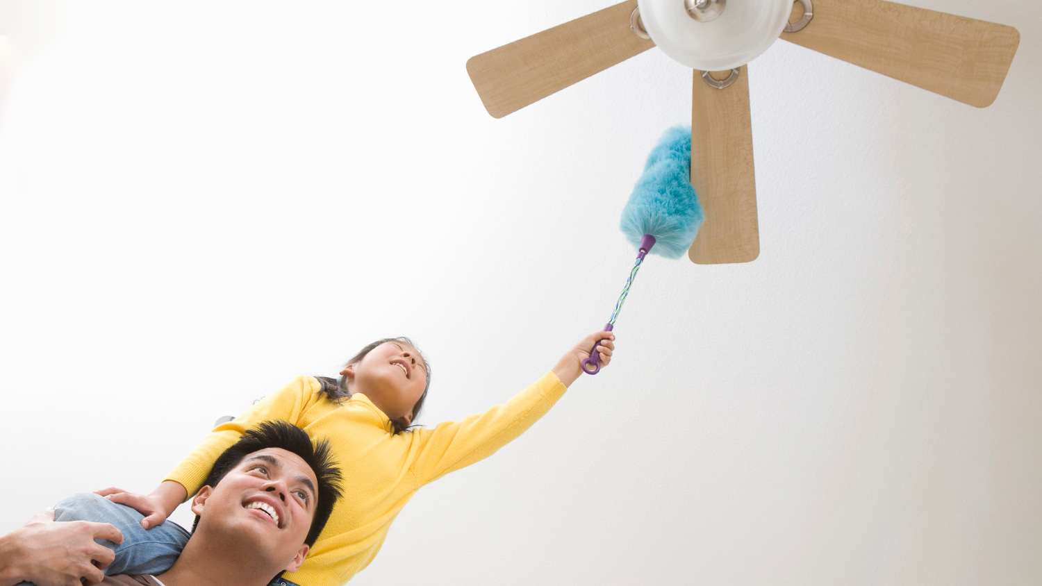 Girl dusting ceiling fan