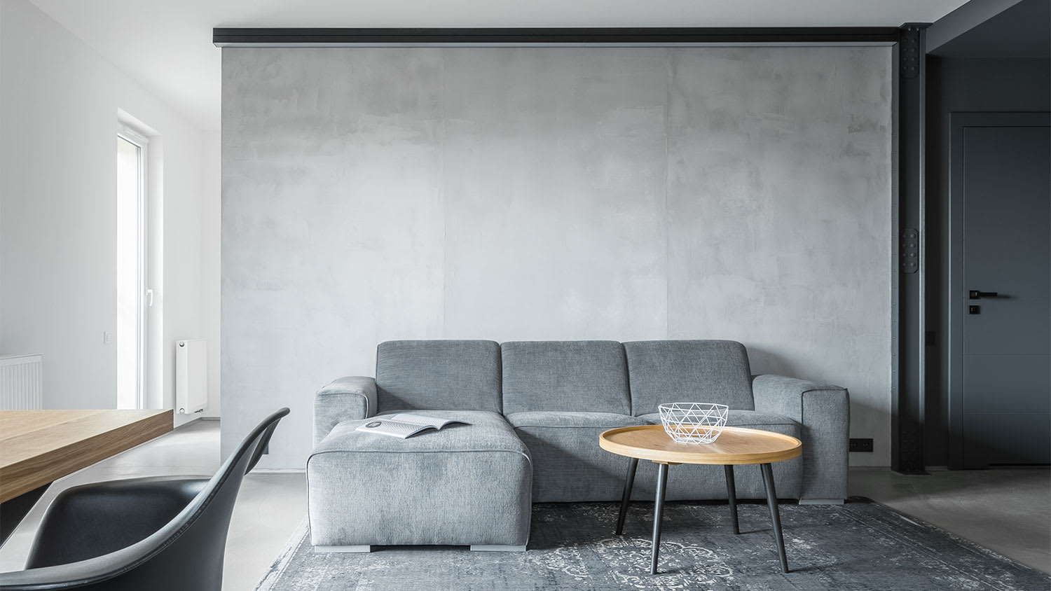 A view of a room with a gray plaster wall
