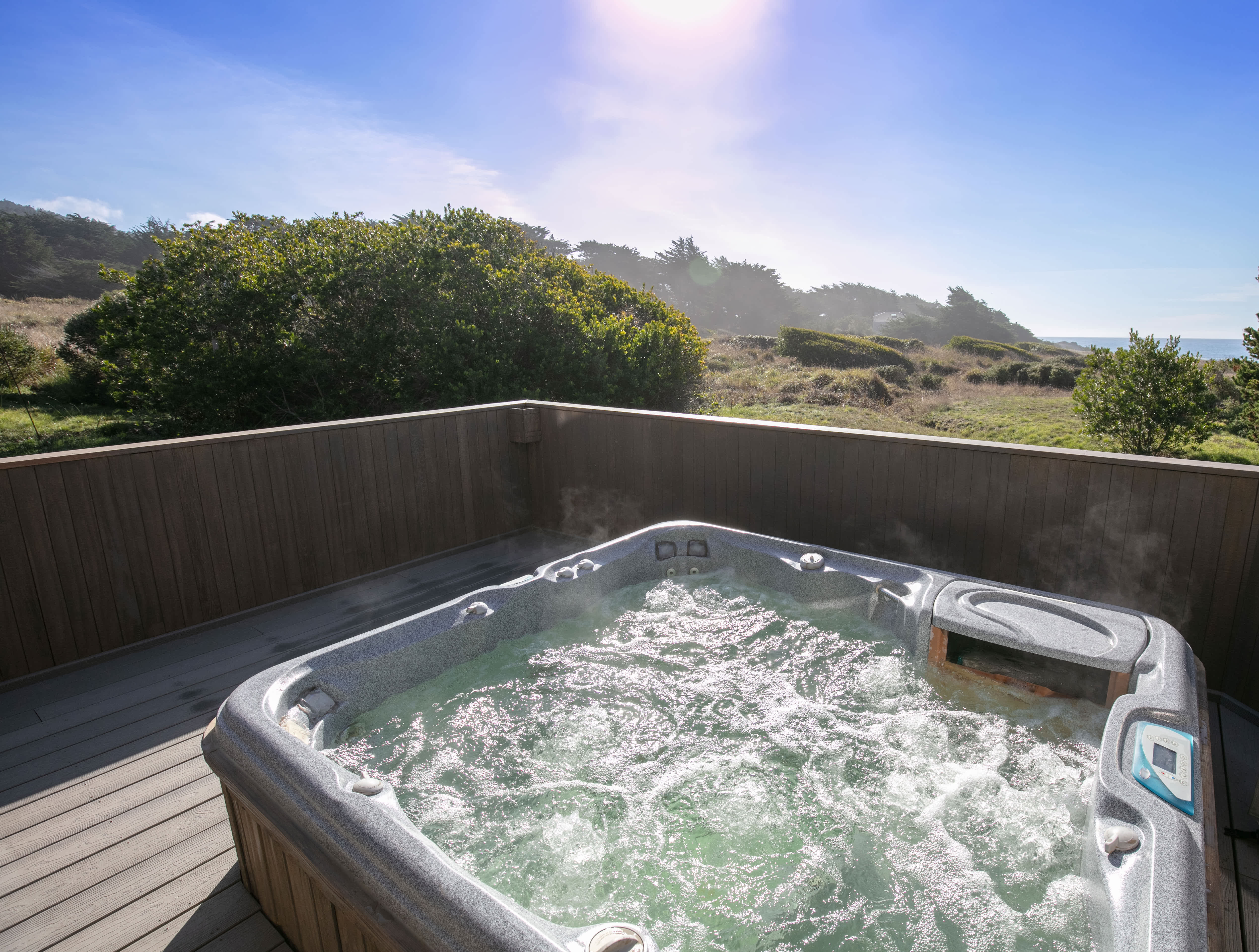 A large hot tub sitting on a composite deck
