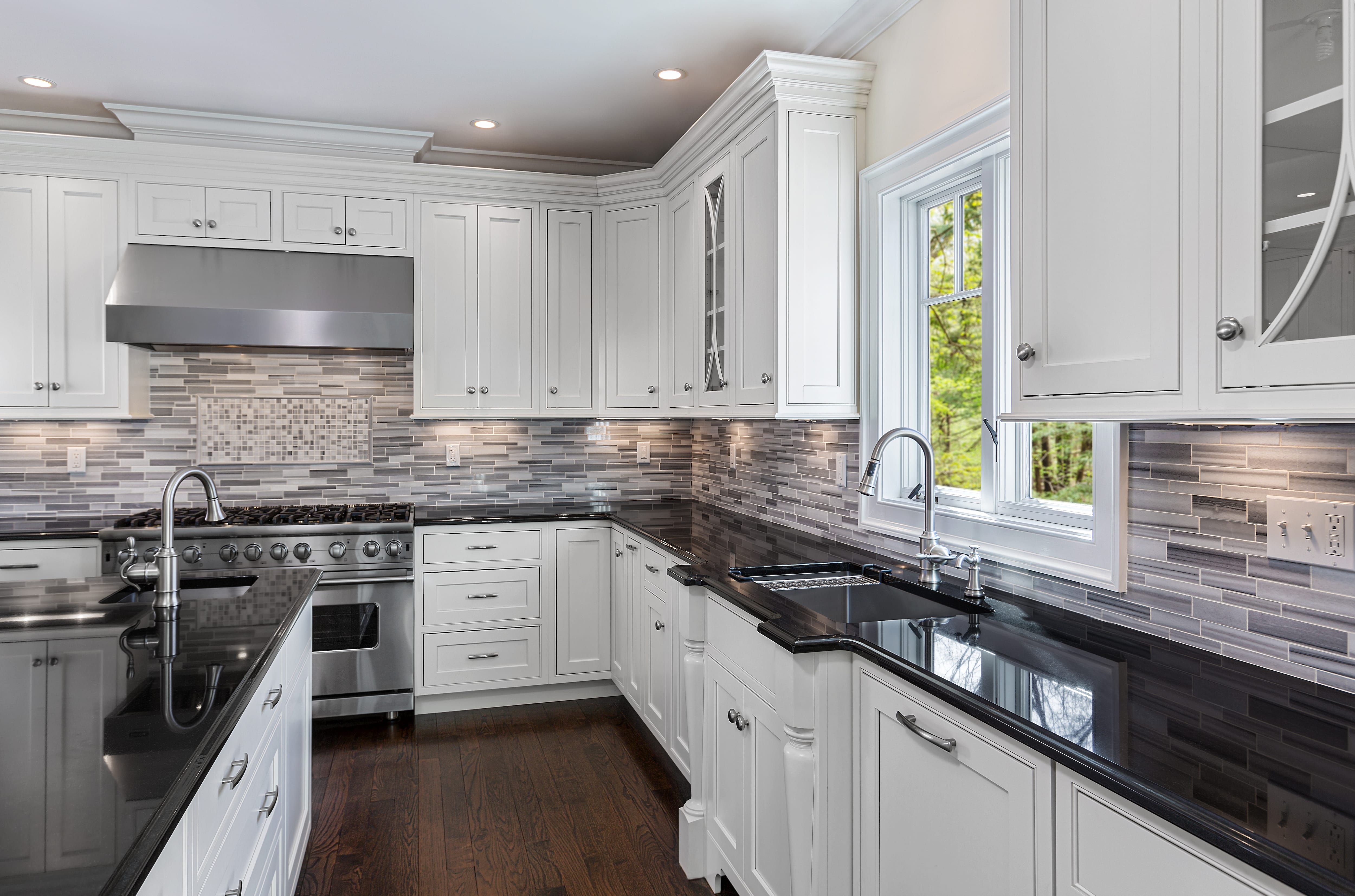 Gray and white striped marble backsplash with a rectangular mosaic focal point
