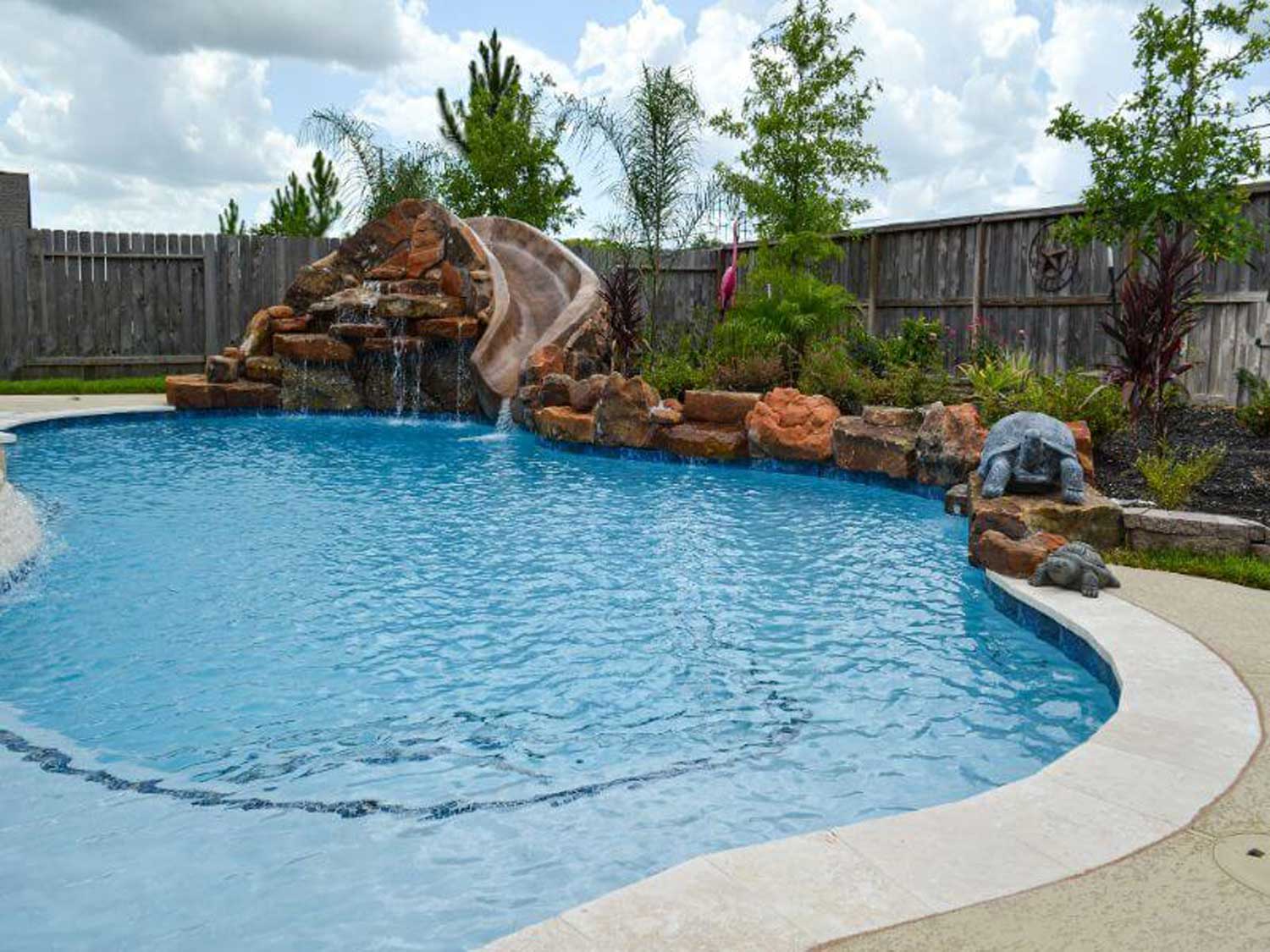 Freeform pool with rock waterfall slide