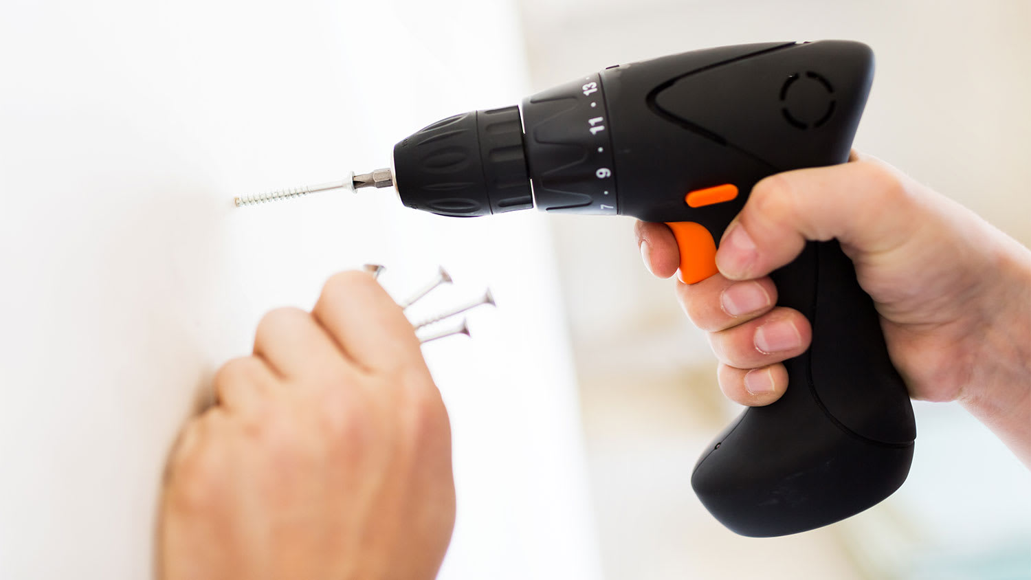 A view of a nail being screwed into a wall