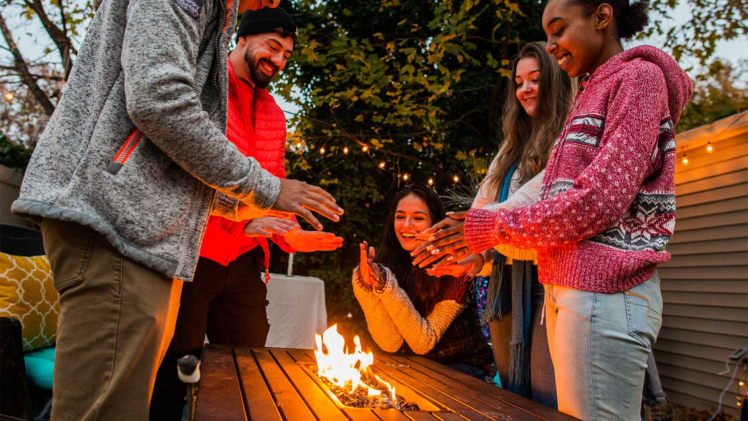A group of friends by a fire pit