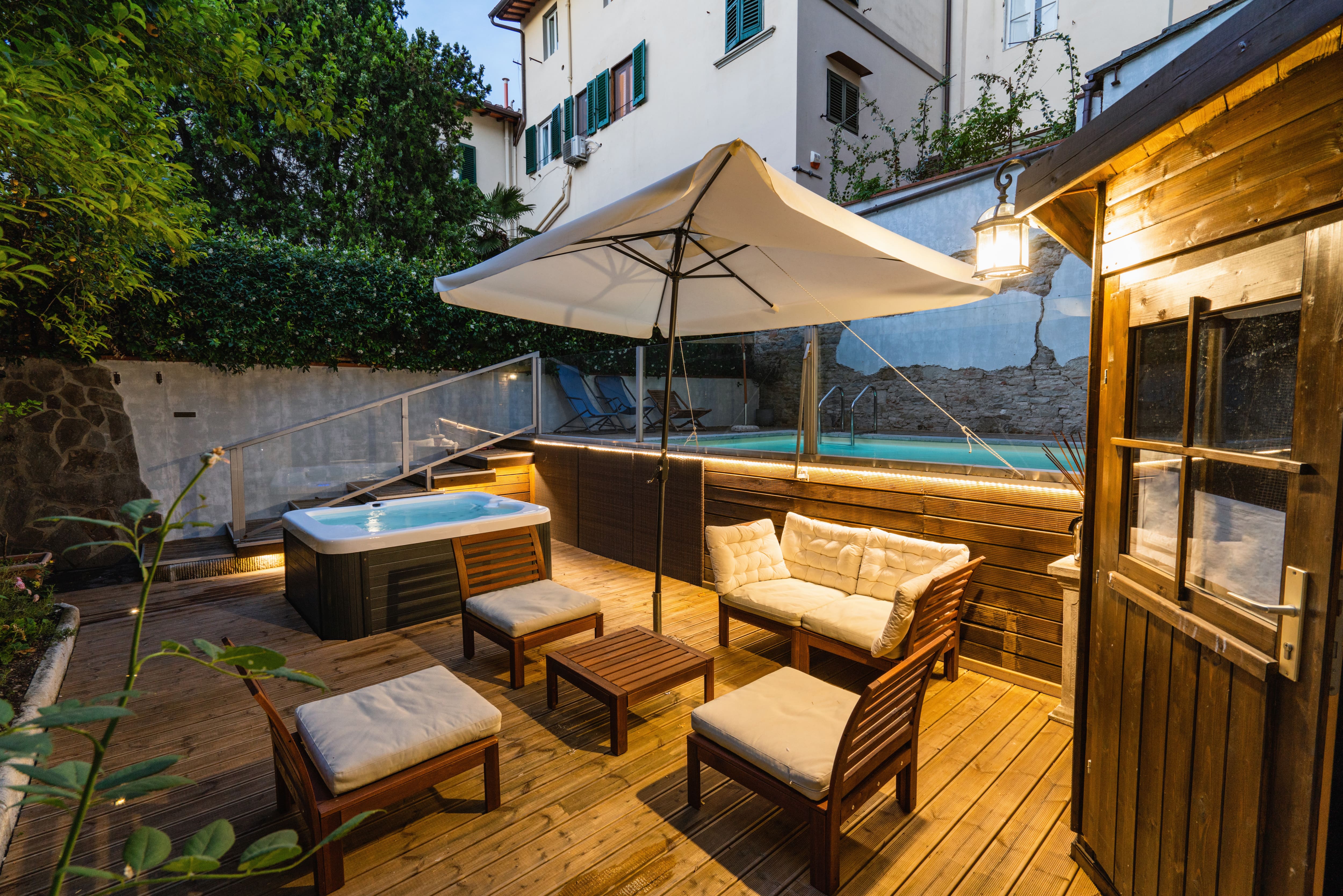 A multi-level deck with a pool and hot tub