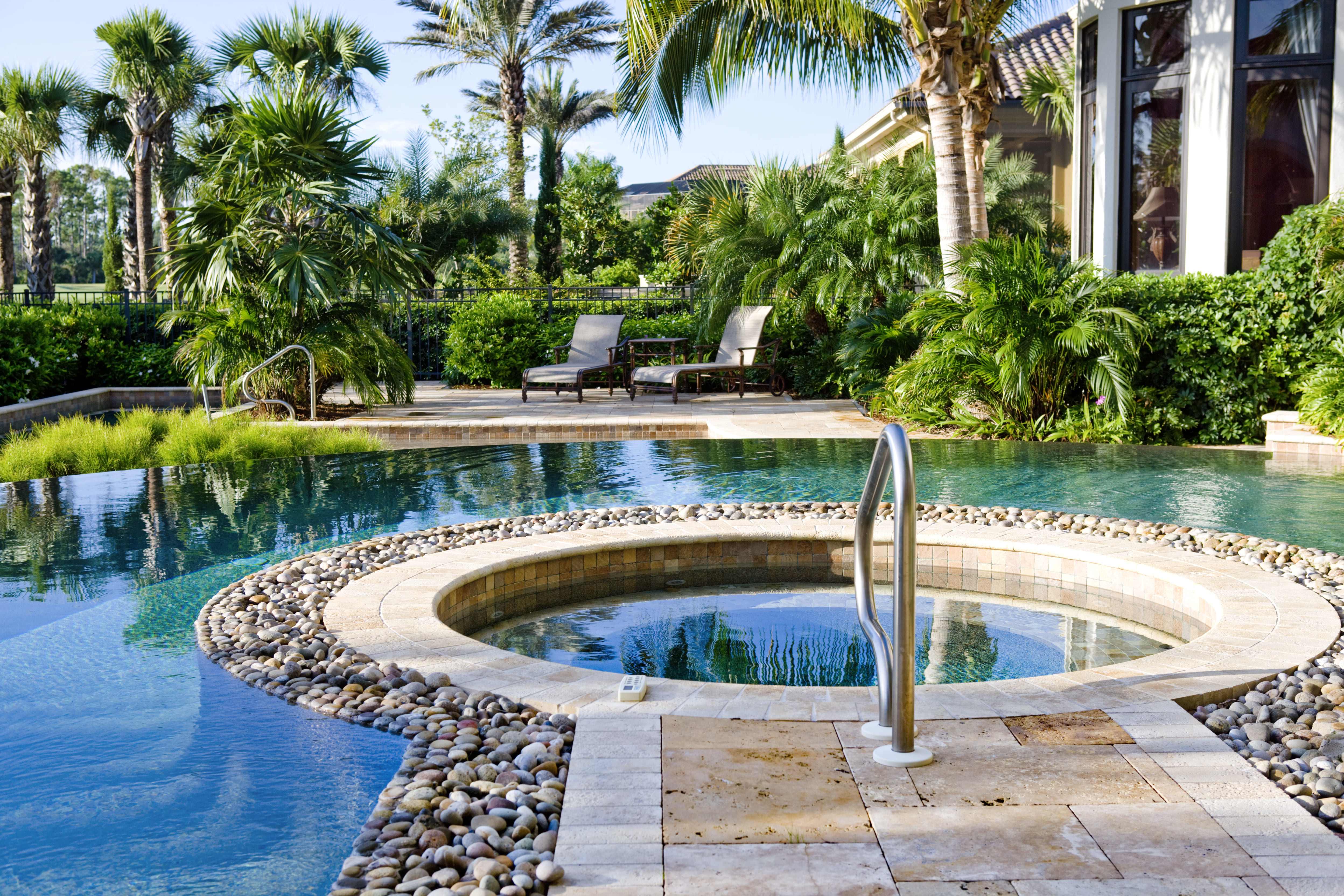 Close up image of an inground hot tub surrounded by stones