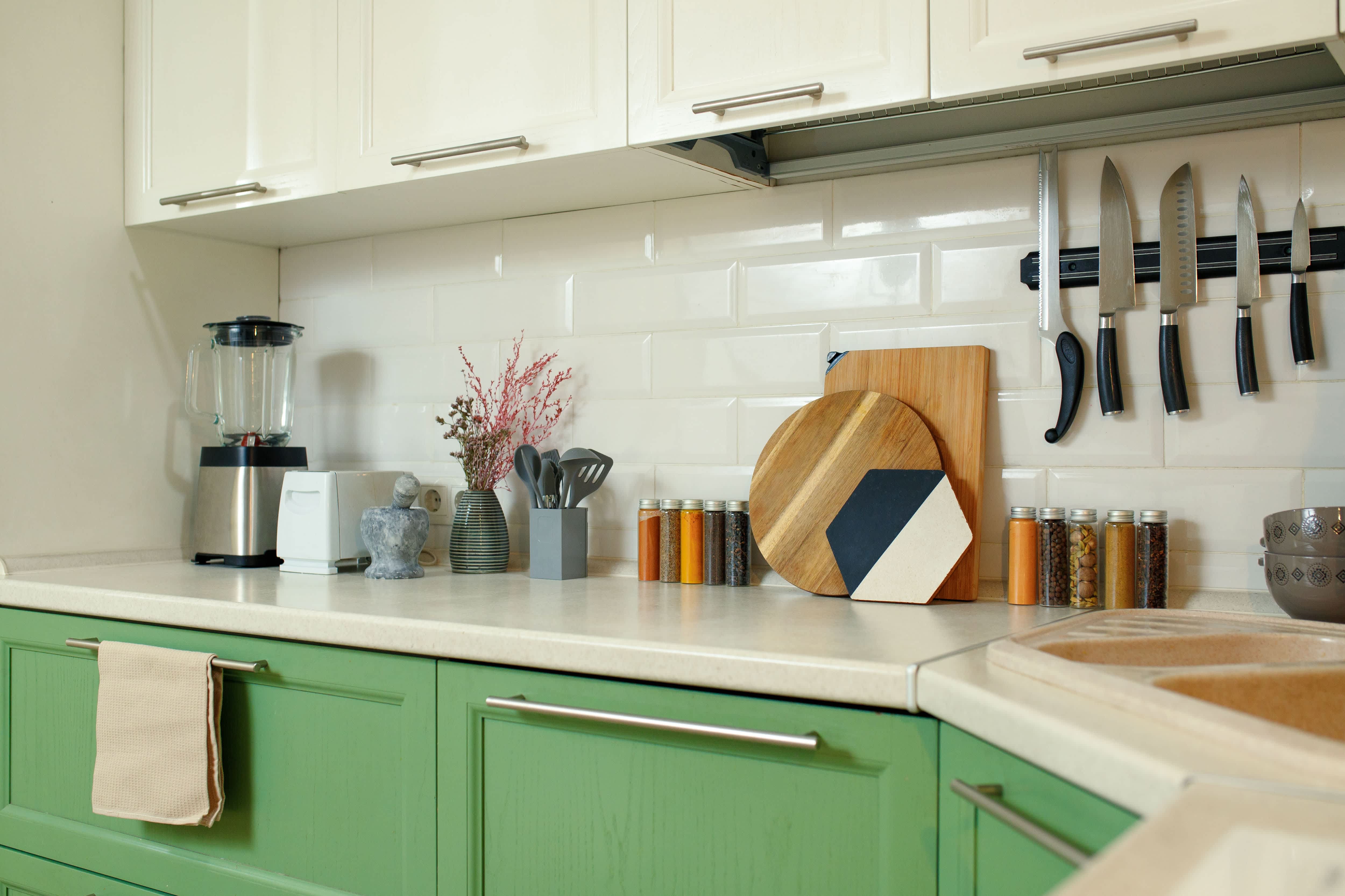Green-and-white kitchen with rectangular beveled backsplash