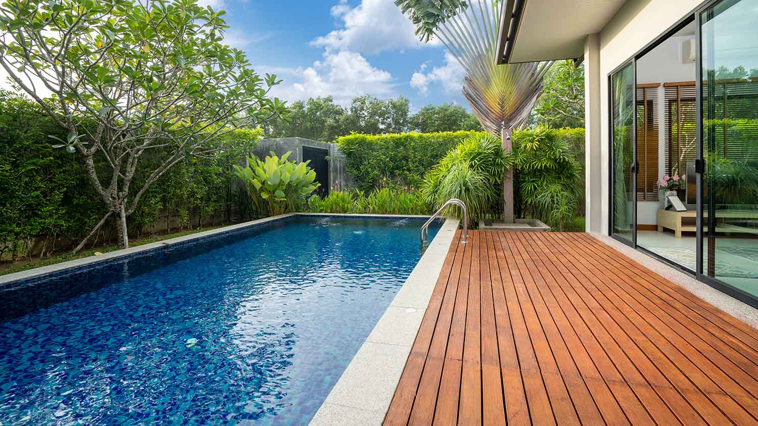 Lap swimming pool with decking in a small backyard