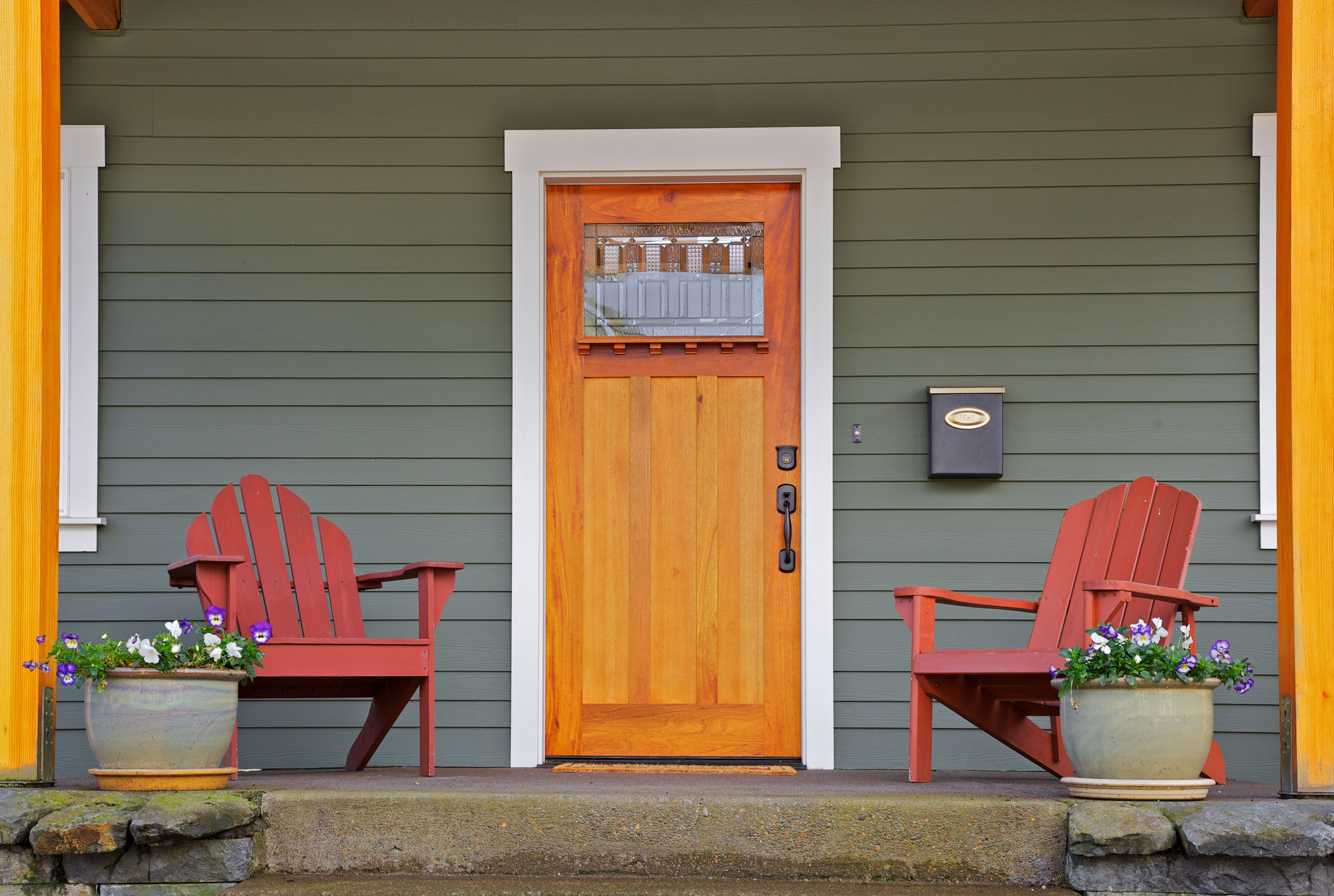 Front porch with two Adirondack chairs in front