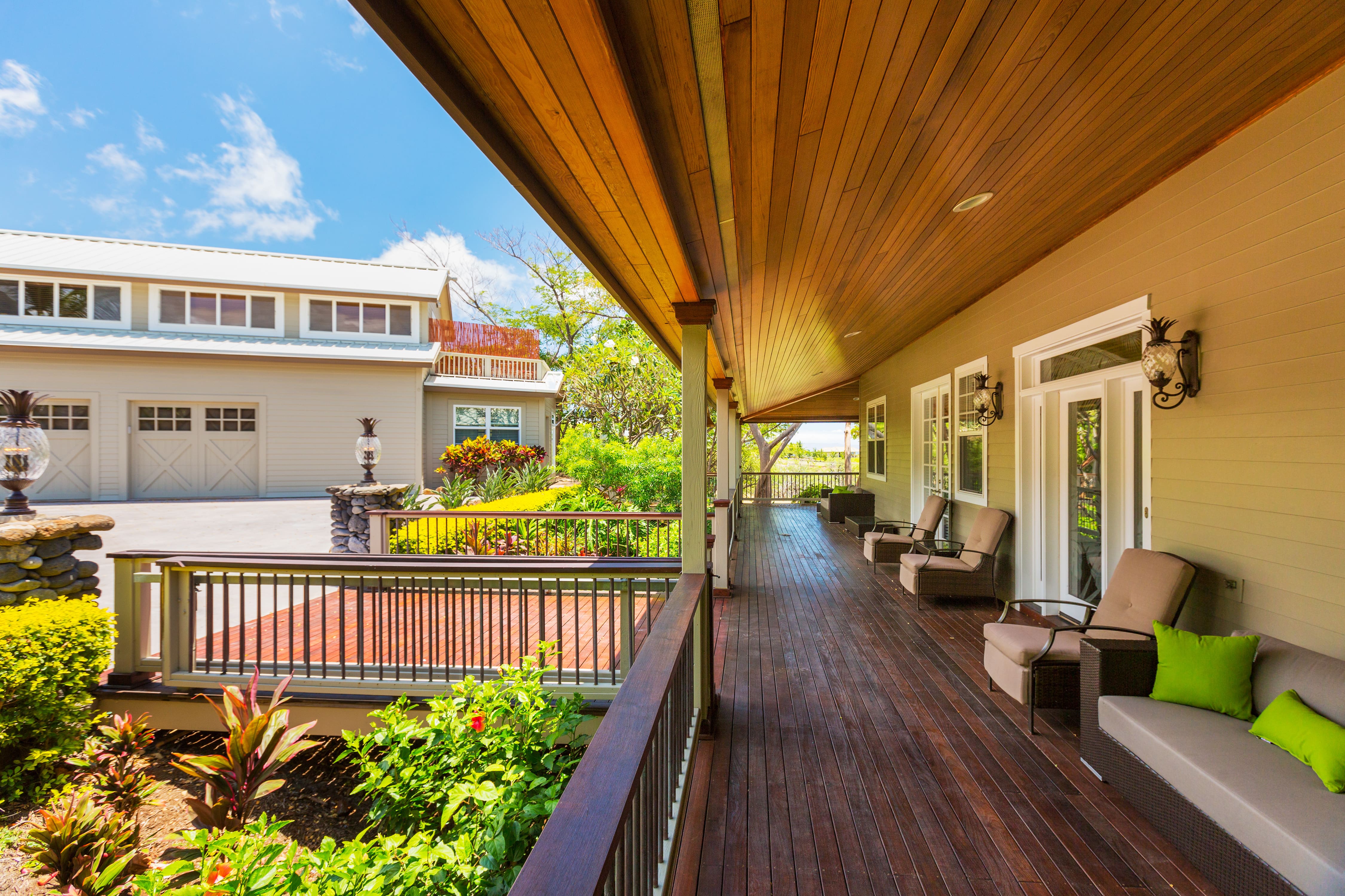 Exterior patio with natural wood ceiling and flooring and neutral patio furniture