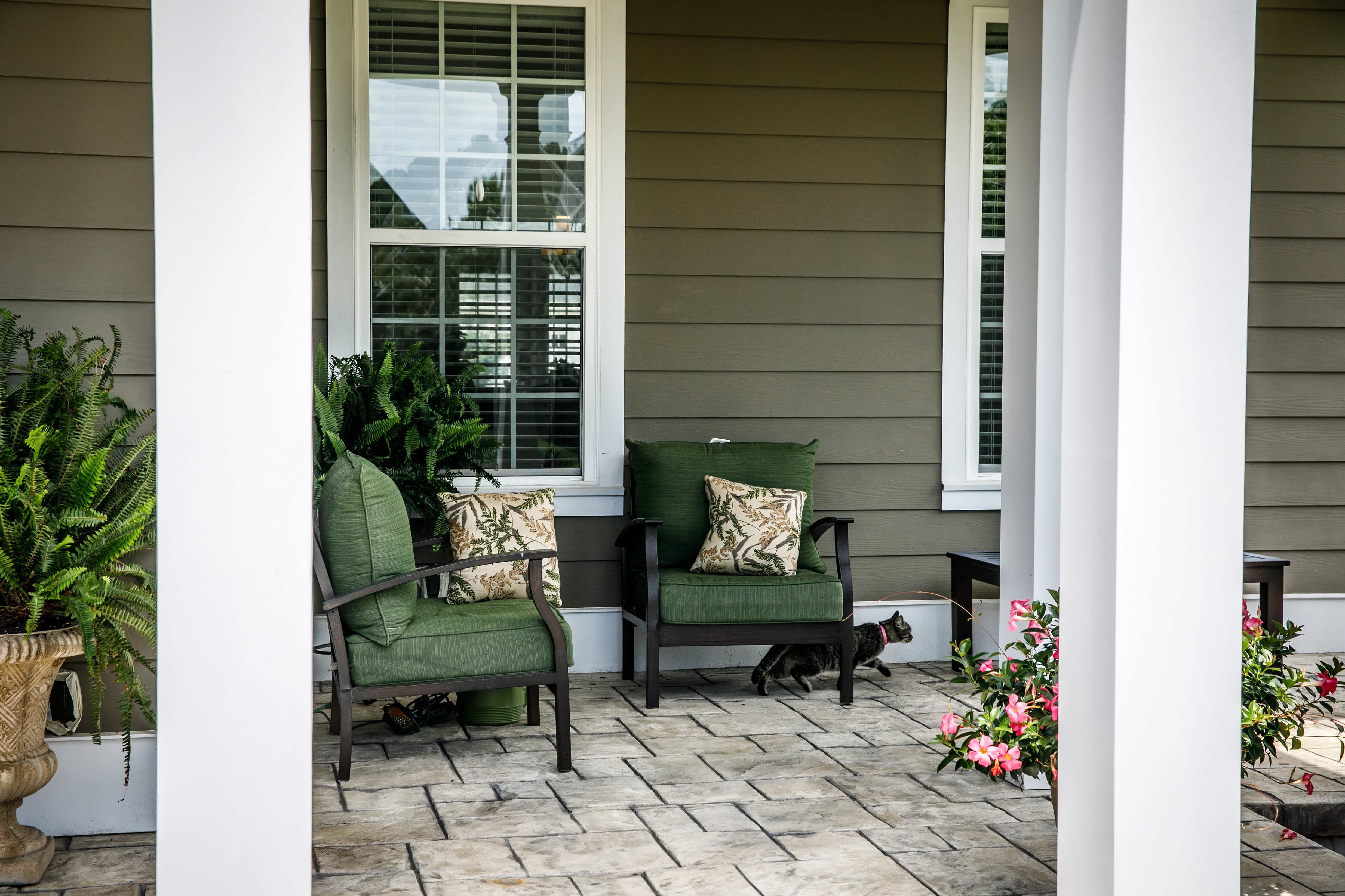 Dark green front porch with conversation chairs