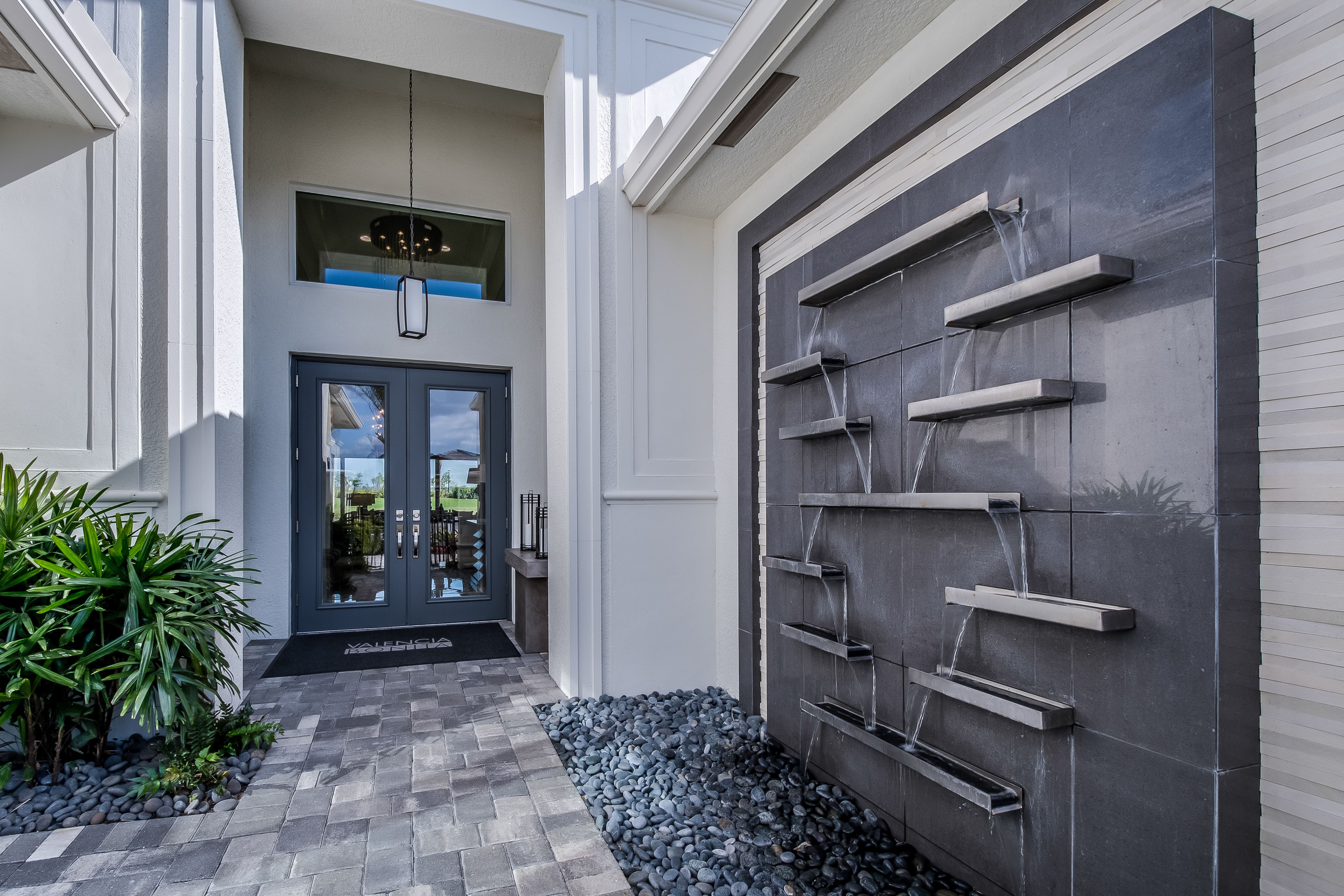 Modern entryway with mounted wall fountain