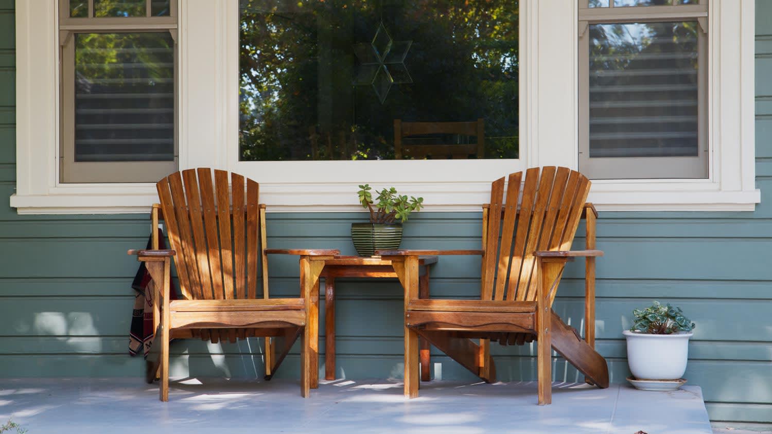 A light blue porch with rocking chair, including different tones of light blue paint