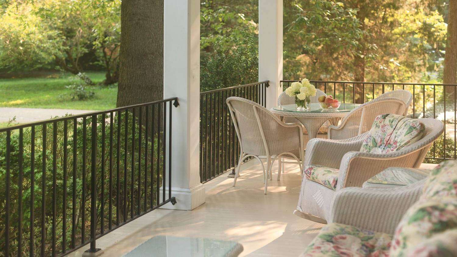 Porch with off white columns and floor, including different tones of off white paint