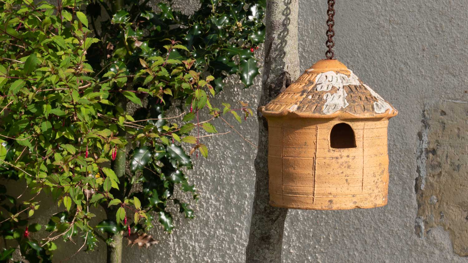 clay birdhouse on a chain