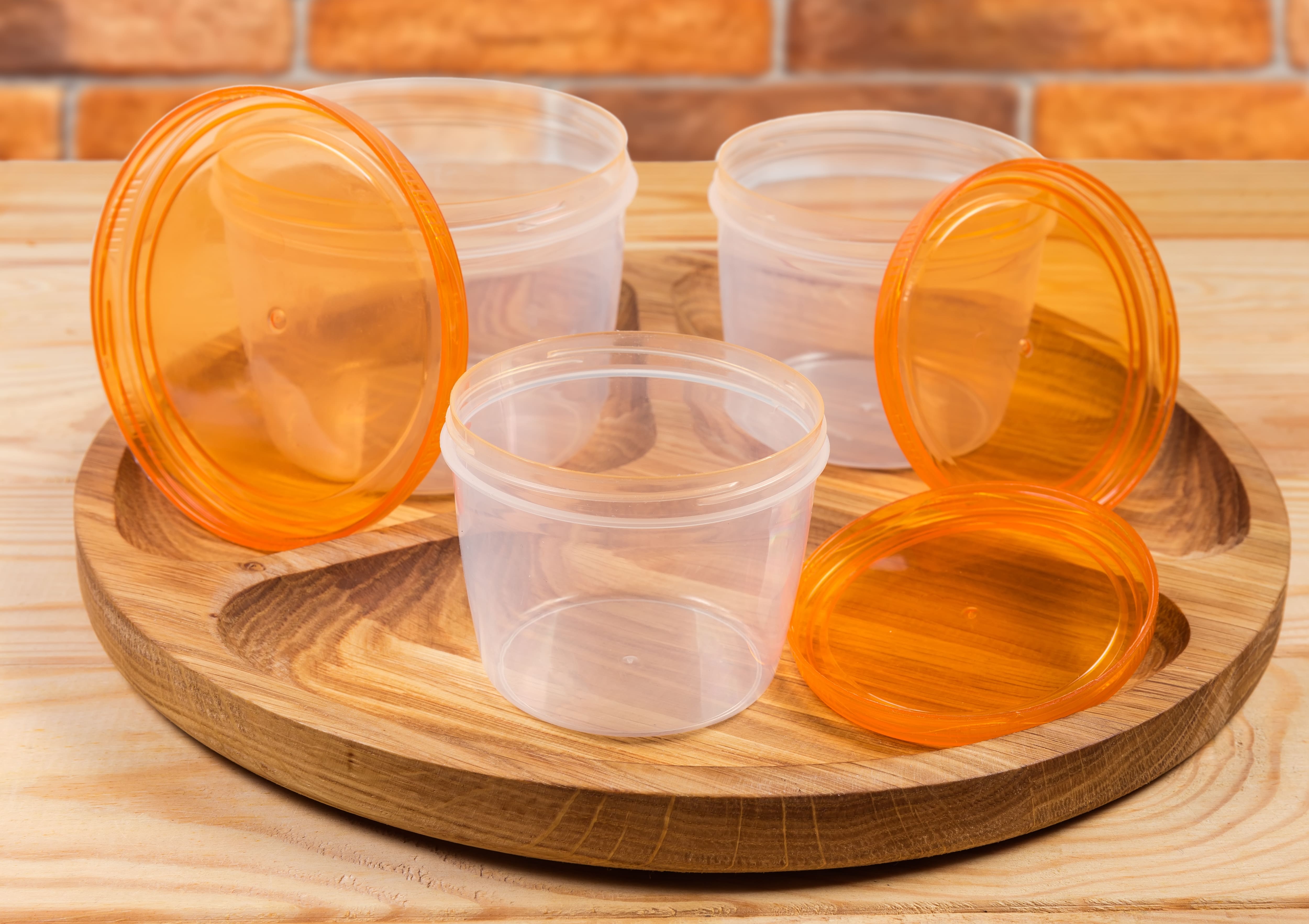 Small round tupperware on top of a wooden lazy susan