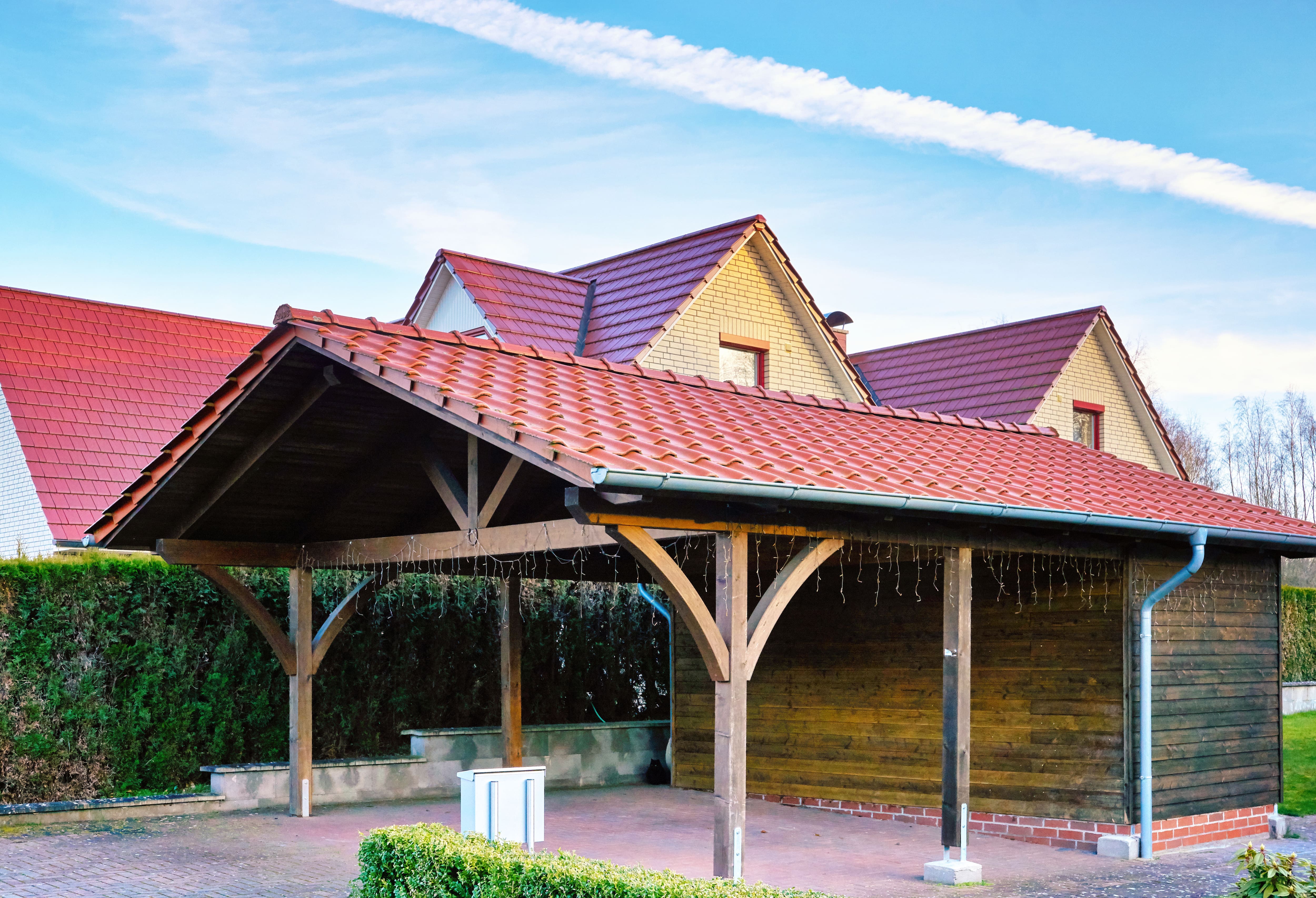 Large cabin-style carport with exposed beams