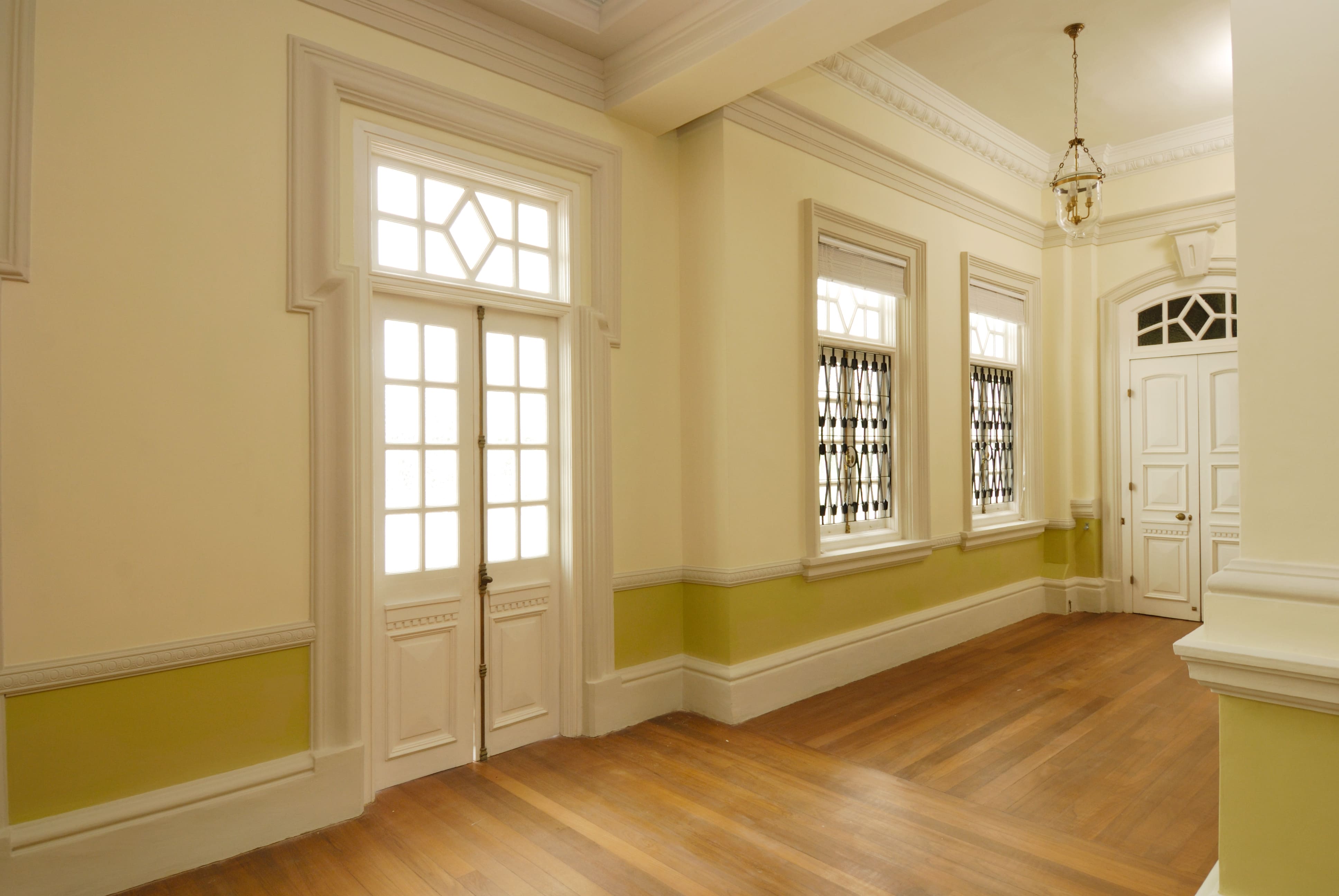 A entryway with two crown molding-framed doors